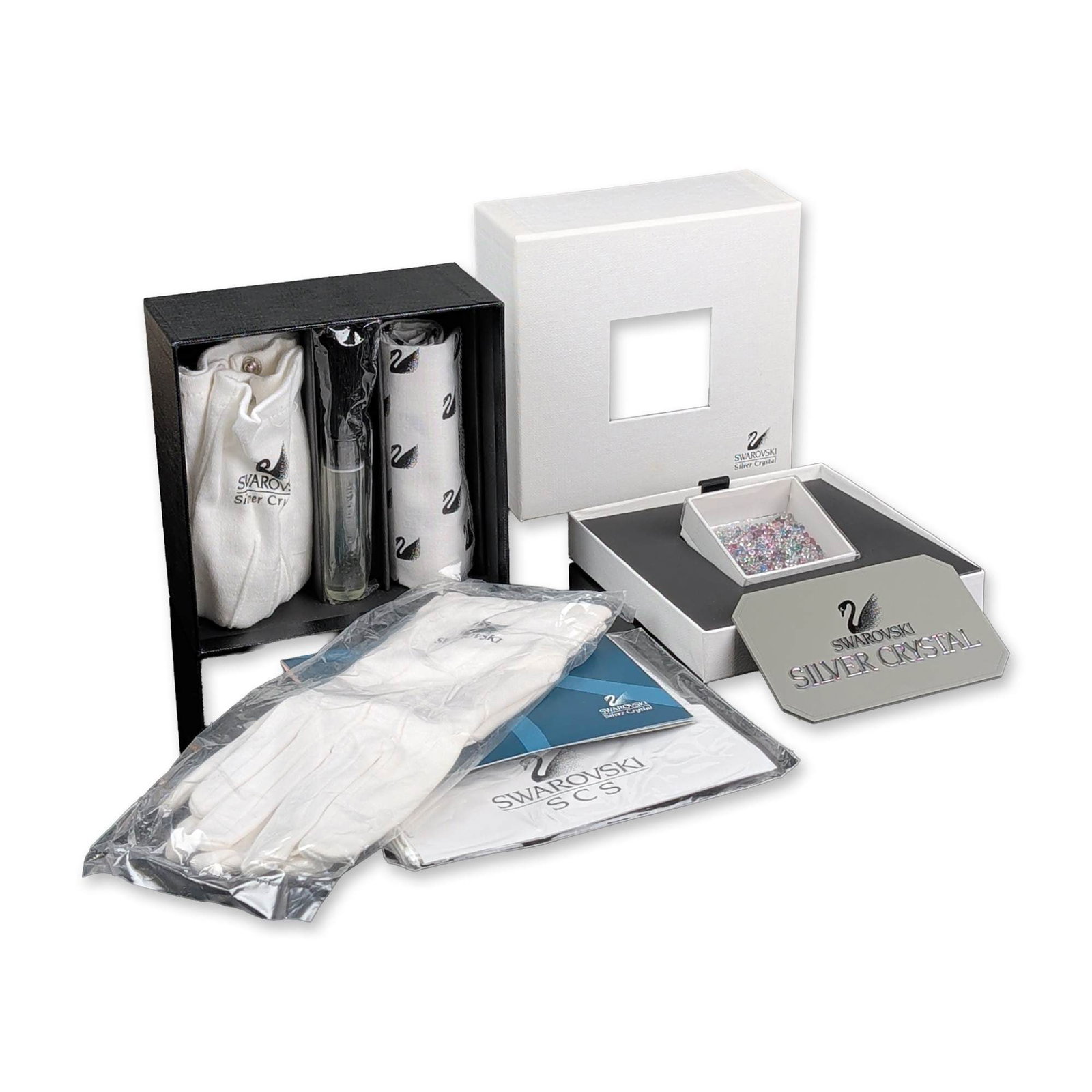 4pc Swarovski SCS Silver Crystal Cleaning Kit, Gloves, Polishing Cloth & Sign: Swarovski SCS professional cleaning and care kit for Silver Crystal figurines and collectibles. The set includes a pair of white cotton branded handling gloves in original plastic packaging, a black-b