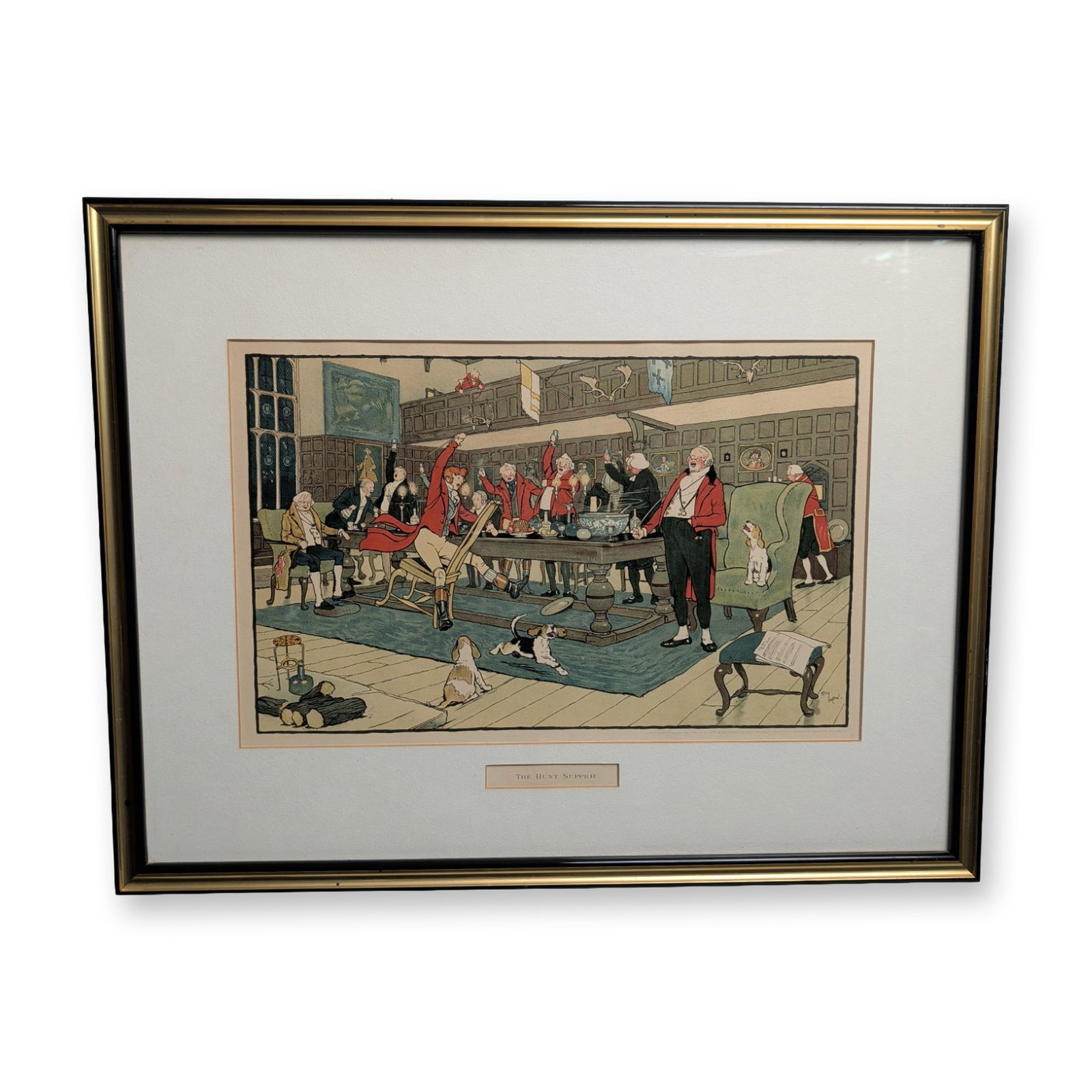 Cecil Aldin (British, 1870-1935) Color Lithograph, The Hunt Supper: Color lithograph on paper after Cecil Aldin, titled "The Hunt Supper." The image depicts a boisterous group of fox hunters in traditional red coats celebrating at a long banquet table, accompanied by 