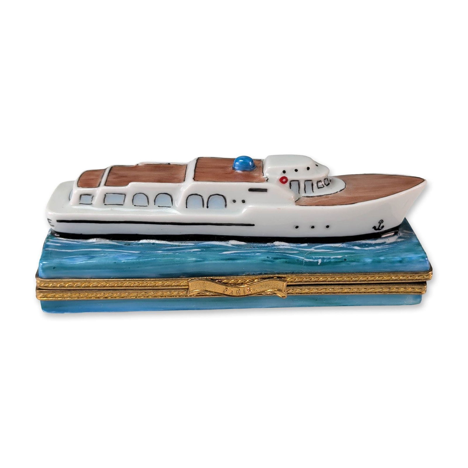 Limoges Carenton Hand Painted Porcelain Excellence Cruise Ship Box: Carenton Porcelaine, Limoges, France hinged porcelain trinket box fashioned as a motor yacht or cruise ship. The hand-painted white vessel features brown deck detailing, a blue cabochon jewel, and a b