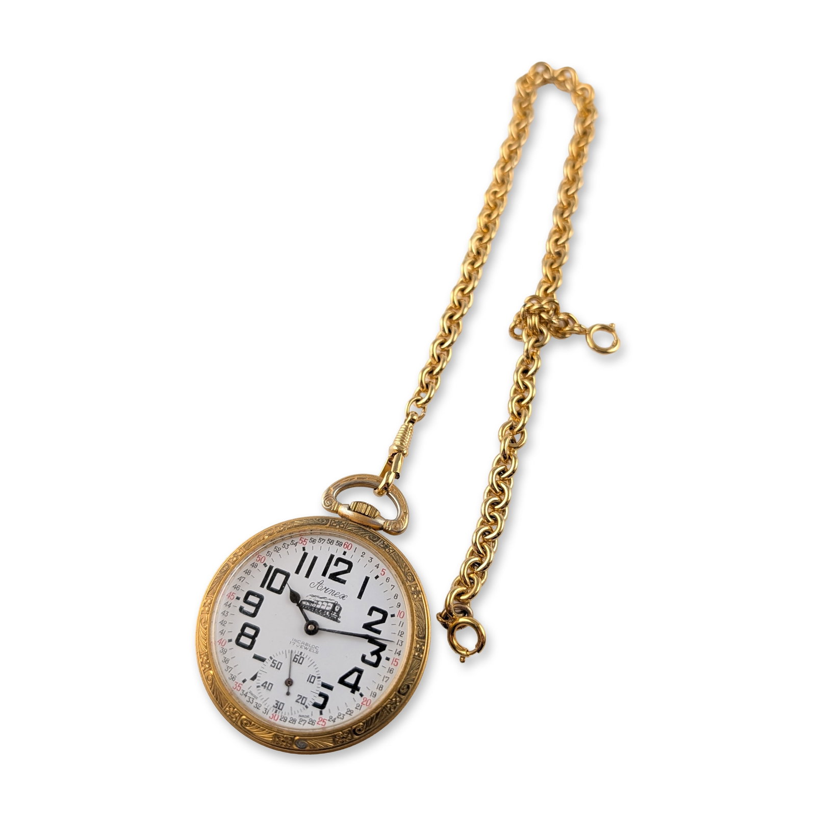 Arnex Swiss Gold-Tone Railroad Pocket Watch: Arnex Swiss-made open face railroad-themed pocket watch in a gold-toned metal case featuring foliate scrollwork decoration to the bezel and case edges. The white Montgomery-style dial displays bold bl