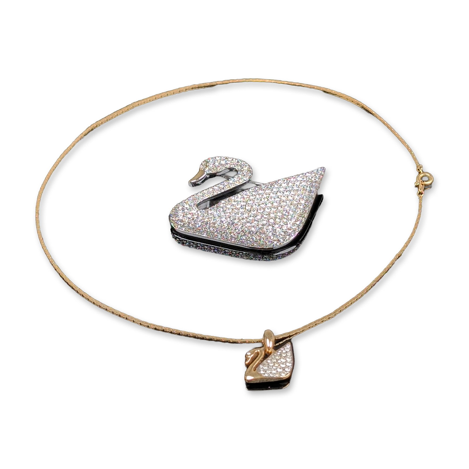 2pc Swarovski Crystal Swan Brooch and Pendant Necklace: Swarovski centennial brooch and pendant necklace in silver and gold-toned metal with pave crystals. The commemorative brooch features a gold-toned beak and colorless pave-set crystals with a teal enam