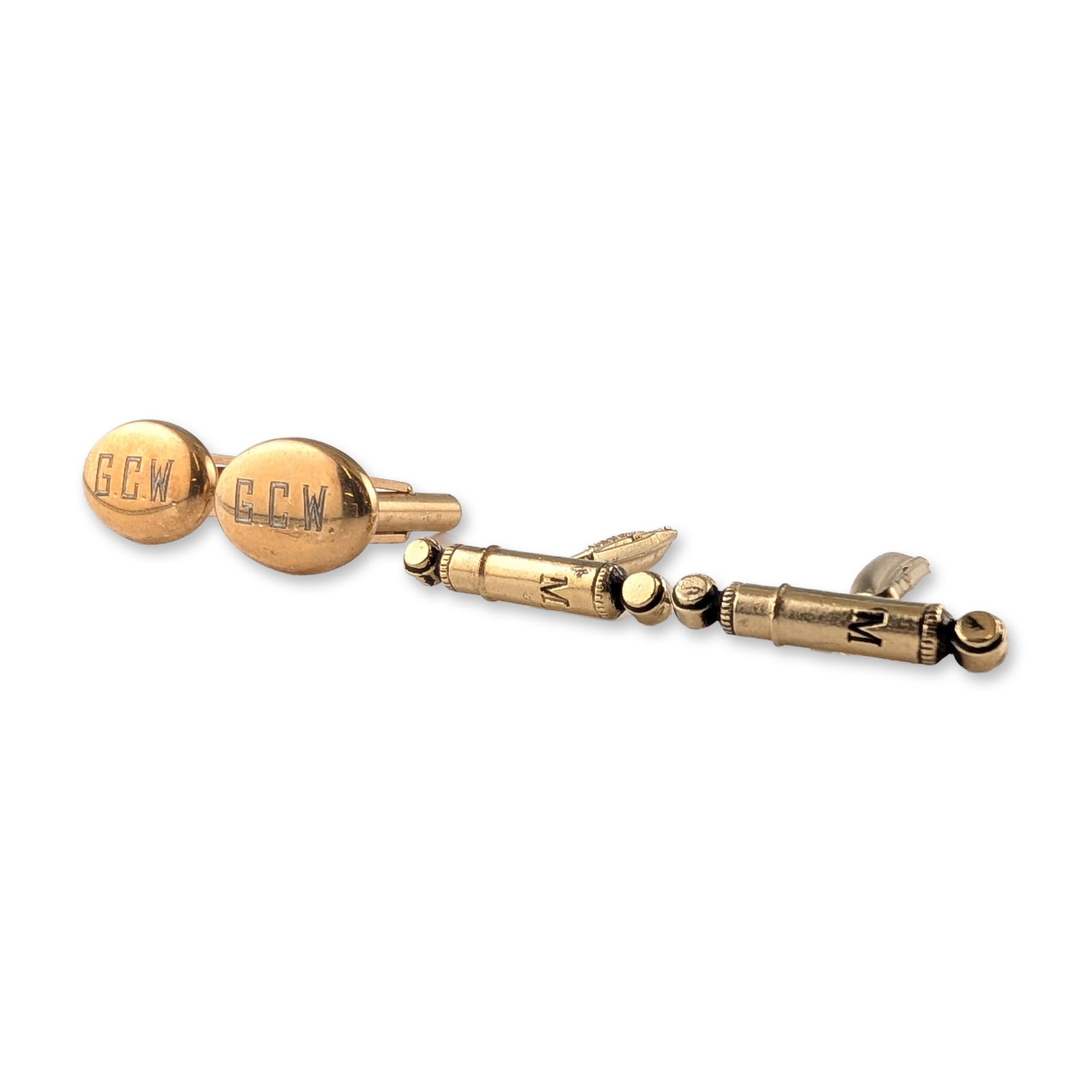 Two Pairs Gold Plated Cufflinks: Collection of two pairs of toggle-back cufflinks. One pair features oval-shaped heads in gold toned with engraved G.C.W. monograms. The second pair consists of gold-toned heads modeled after