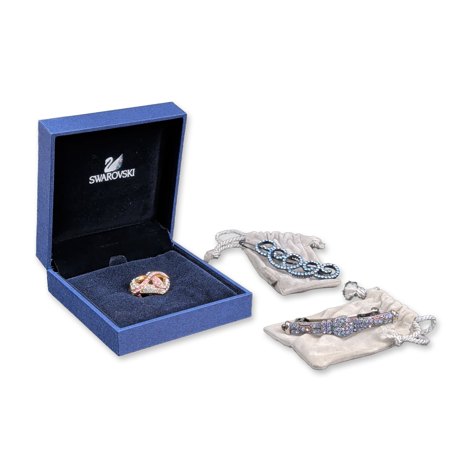 3pc Swarovski Crystal Pink Hope Pin and Hair Barrettes: Three jewelry items including one pin and two hair barrettes. The rose gold-tone metal pin features a crossover infinity-loop design pave-set with round-cut pink and clear crystals, marked with the Sw
