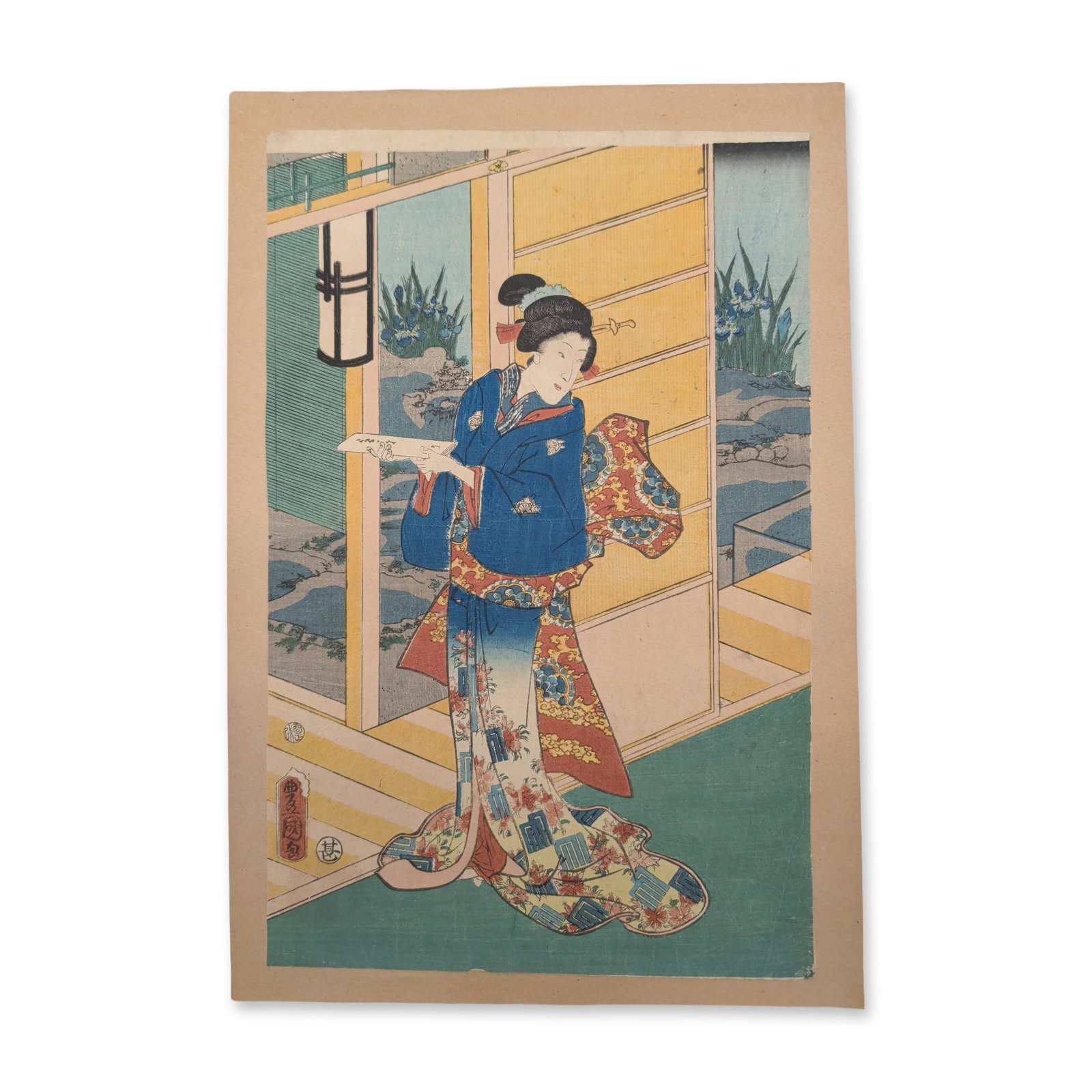 Utagawa Kunisada (Toyokuni III) (Japanese, 1786-1865) Woodcut from One Hundred Famous Places and: A central beauty in a brilliantly patterned blue kimono stands on a wooden veranda, looking back over her shoulder while holding a small, folded piece of paper in her hand. Behind her, open sliding sc