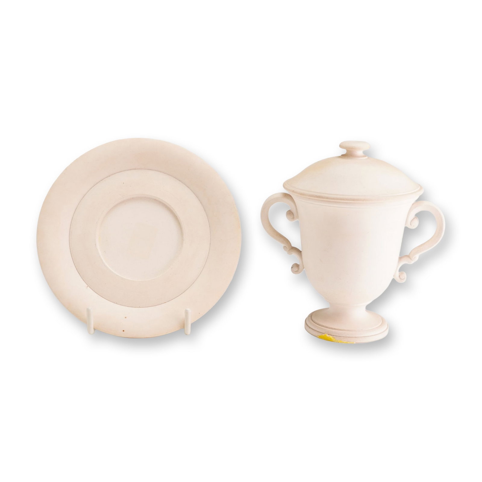 Wedgwood Biscuit Porcelain Lidded Lemonade Cup and Saucer, ca. 1820: This set comprises a two-handled lidded cup and a matching saucer produced by Wedgwood. The items are crafted from a creamy-white dry-bodied stoneware, also referred to as biscuit porcelain or whitewa