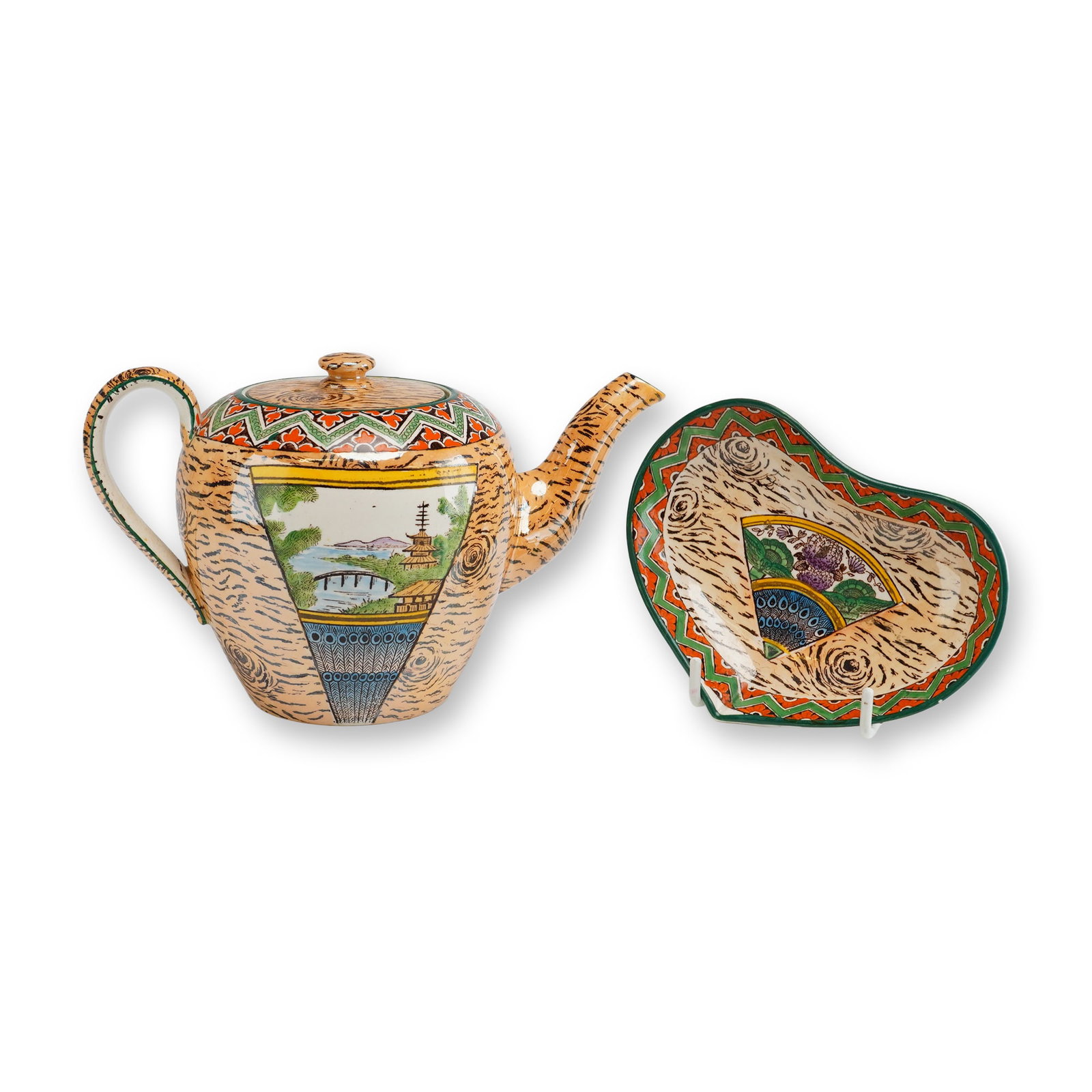 Two Piece Wedgwood Japanese Style Glazed Earthenware Teapot and Dish: This two piece set consists of a lidded teapot and a coordinating kidney shaped dish, both manufactured by Wedgwood in the Japonisme style. The pieces are crafted from glazed earthenware, likely cream