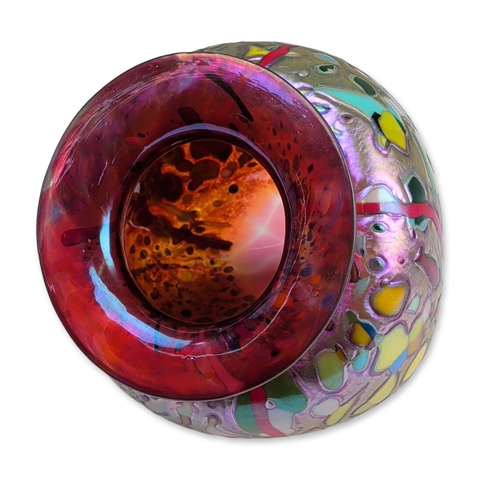 Rick Hunter Iridescent Asymmetrical Glass Vase: Hand-blown art glass vase in iridescent glass, featuring a squat bulbous form with a wide flared rim in translucent ruby red. The body is decorated with multicolored cell-like inclusions in yellow, bl