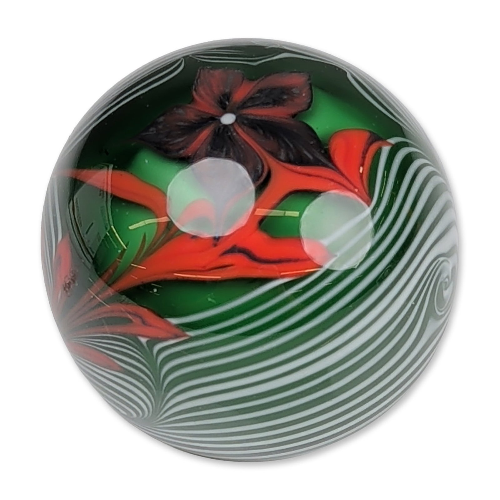 Bridgeton Studio by Fritz Wille 1977 Art Glass Paperweight: Bridgeton Studio art glass paperweight, 1977, featuring an opaque green glass core with a white King Tut style pulled-thread spiral. The interior contains a lampworked botanical arrangement with a red