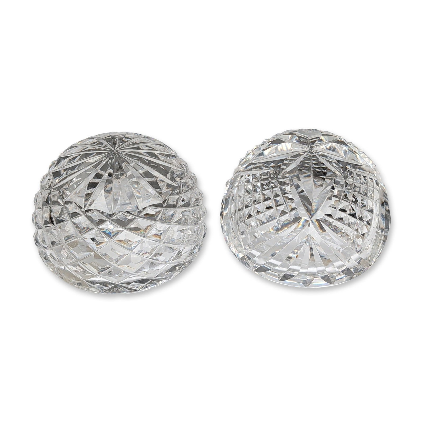 Pair of Waterford Cut Crystal Hollow Dome Paperweights: Waterford Crystal, Ireland. Pair of hollow decorative paperweights in lead crystal, featuring hand-cut geometric patterns. One weight is decorated with a swirling diamond-cut pattern, while the other 