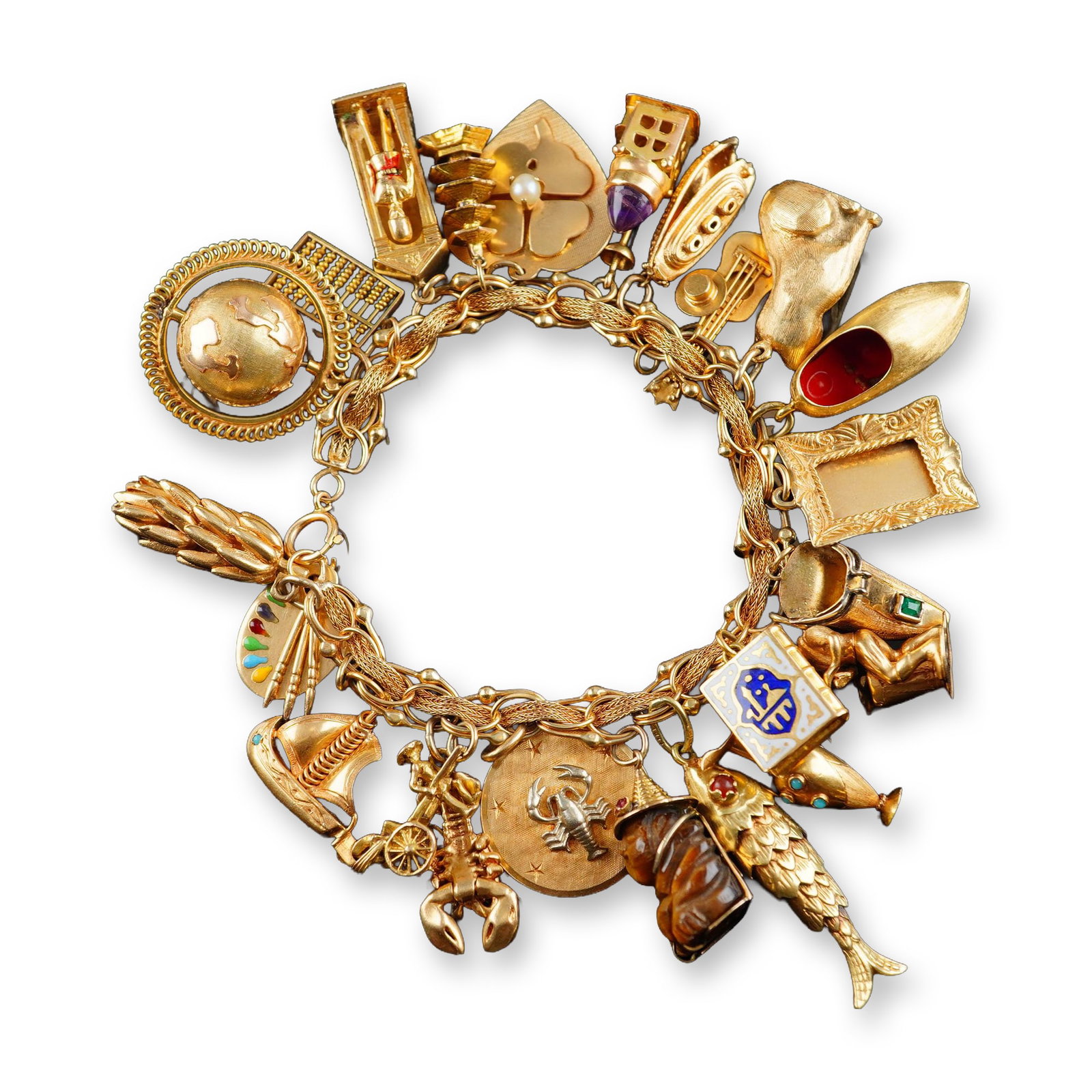 14K Gold Bracelet with 23 Unique Charms: One of a kind bracelet crafted from 14K gold featuring 23 gold charms. All charms are 14K except one shoe shaped with an emerald that is 18K gold and a guard soldier is marked 375 which is an English 