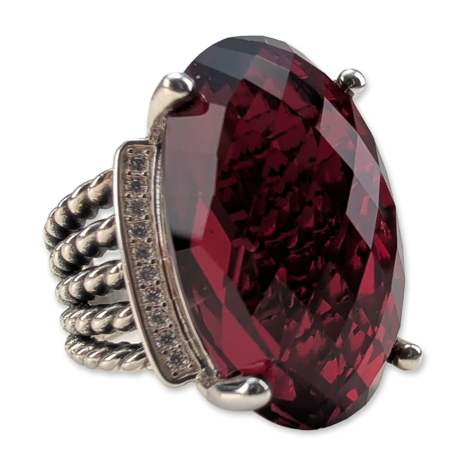 David Yurman Sterling Silver Wheaton Garnet and Diamonds Ring: David Yurman Wheaton collection cocktail ring in sterling silver, featuring a large oval checkerboard-faceted garnet of a deep purplish-red color. The center stone is held in a four-prong setting flan