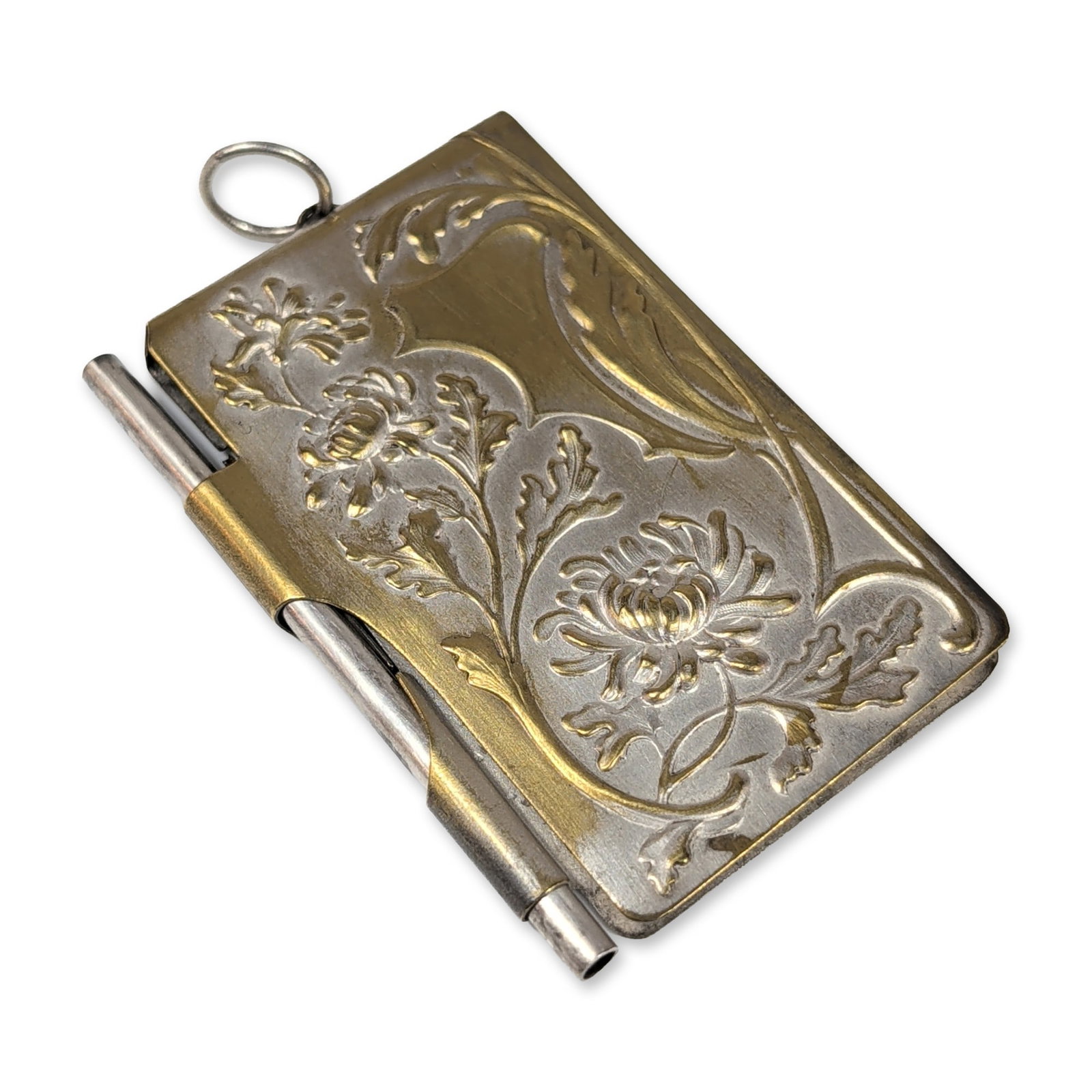 Art Nouveau Silver Plated Dance Card Pendant: Art Nouveau pocket notebook holder, or carnet de bal, in silver-plated base metal featuring repousse decoration. The front cover depicts a chrysanthemum blossom with scrolling foliage, and the reverse