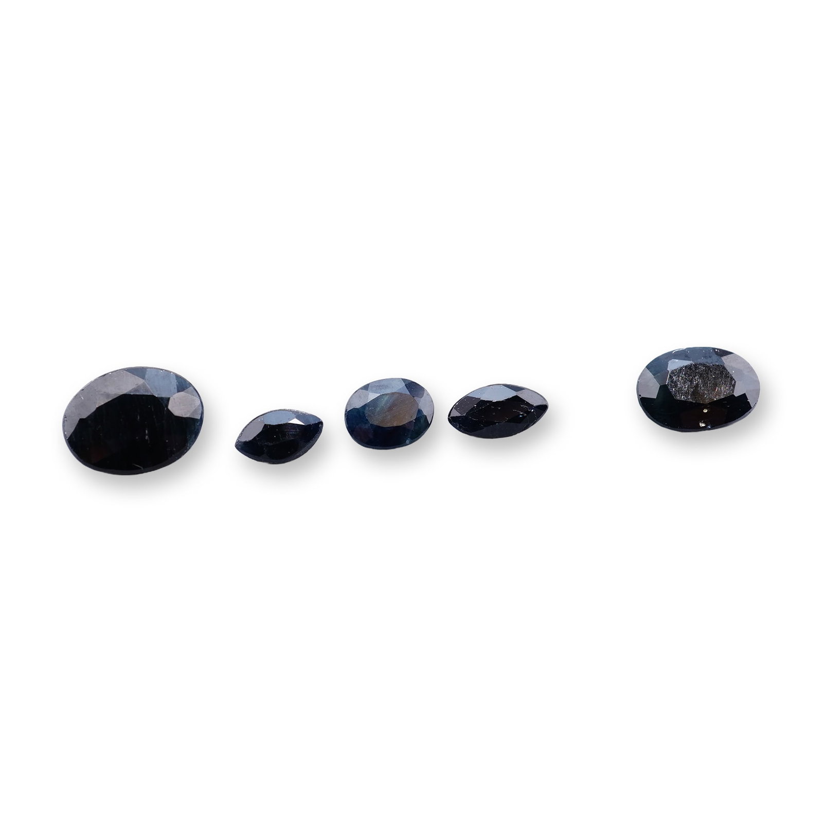 6pc Loose Faceted Deep Blue Sapphires: Loose faceted gemstone appearing to be blue topaz. The stone features a classic rectangular emerald cut with step-cut facets and a pale, icy blue color. The gemstone exhibits high transparency and cla