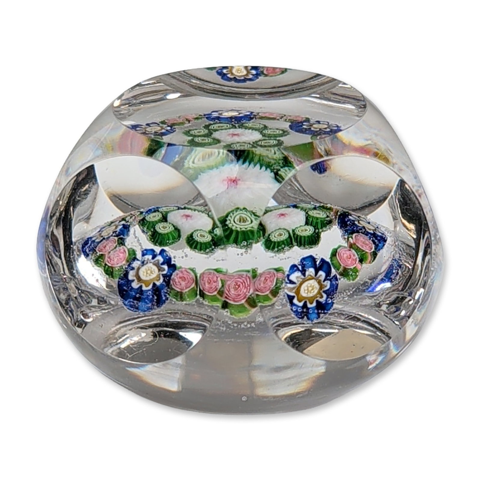 Antique Clichy Faceted Millefiori Glass Paperweight: Clichy, France, circa 1848. Faceted millefiori glass paperweight in clear glass, featuring one circular top facet and five circular side facets. The internal concentric arrangement includes a central 