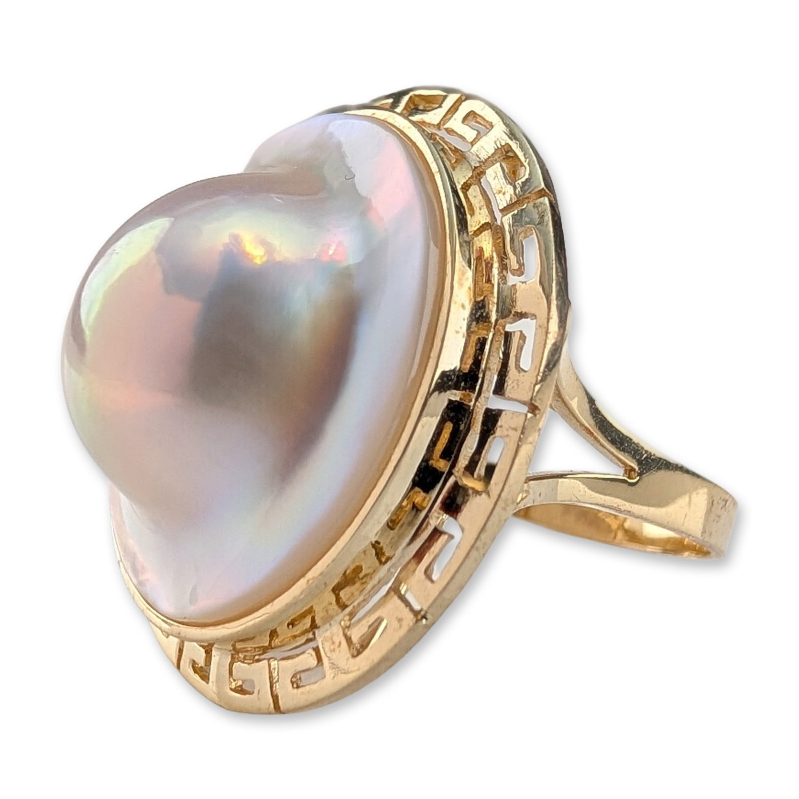 14K Yellow Gold and Mabe Pearl Greek Key Ring: A 14 karat yellow gold cocktail ring featuring a large high-domed mabe pearl. The pearl displays a creamy-white body color with prominent iridescent orient and is secured in a polished bezel setting. 