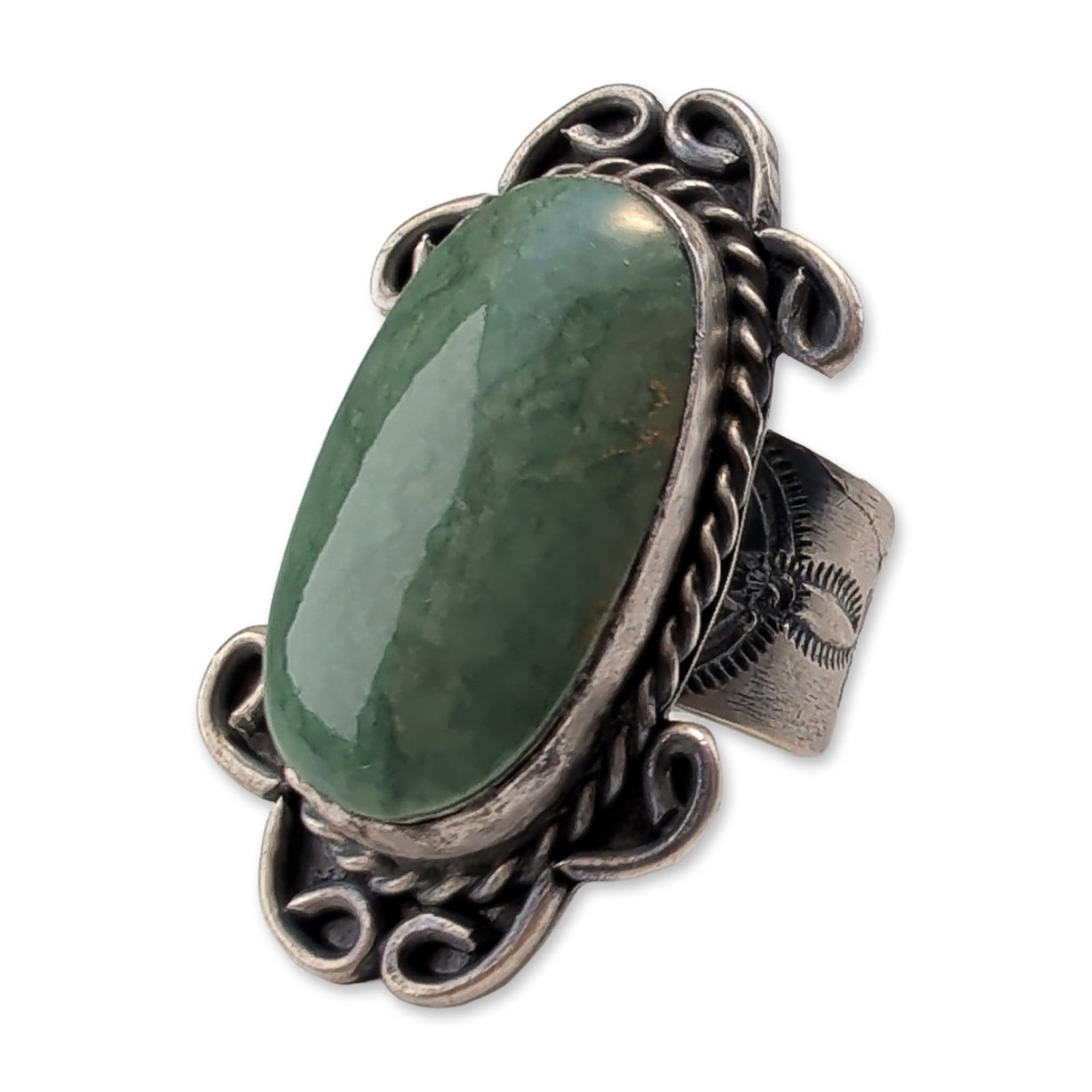 Bell Trading Post Sterling Silver Jade Ring: Bell Trading Post Southwestern ring in sterling silver, featuring a large oval green jade cabochon in a bezel setting. The central stone is bordered by a twisted rope wire and four scrolled silver acc
