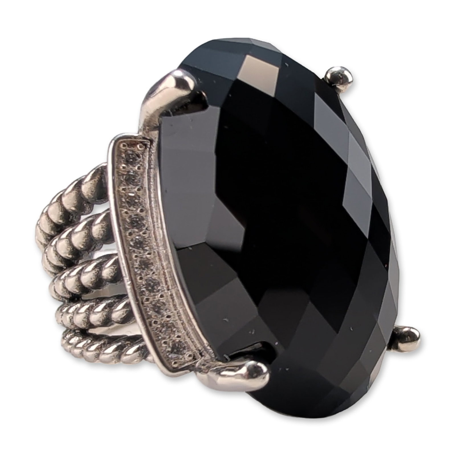 David Yurman Sterling Silver Wheaton Onyx Diamond Ring: David Yurman Wheaton ring in .925 sterling silver, featuring a central faceted oval black onyx held by four prongs. The setting includes a horizontal curved bar pave-set with round brilliant-cut diamo