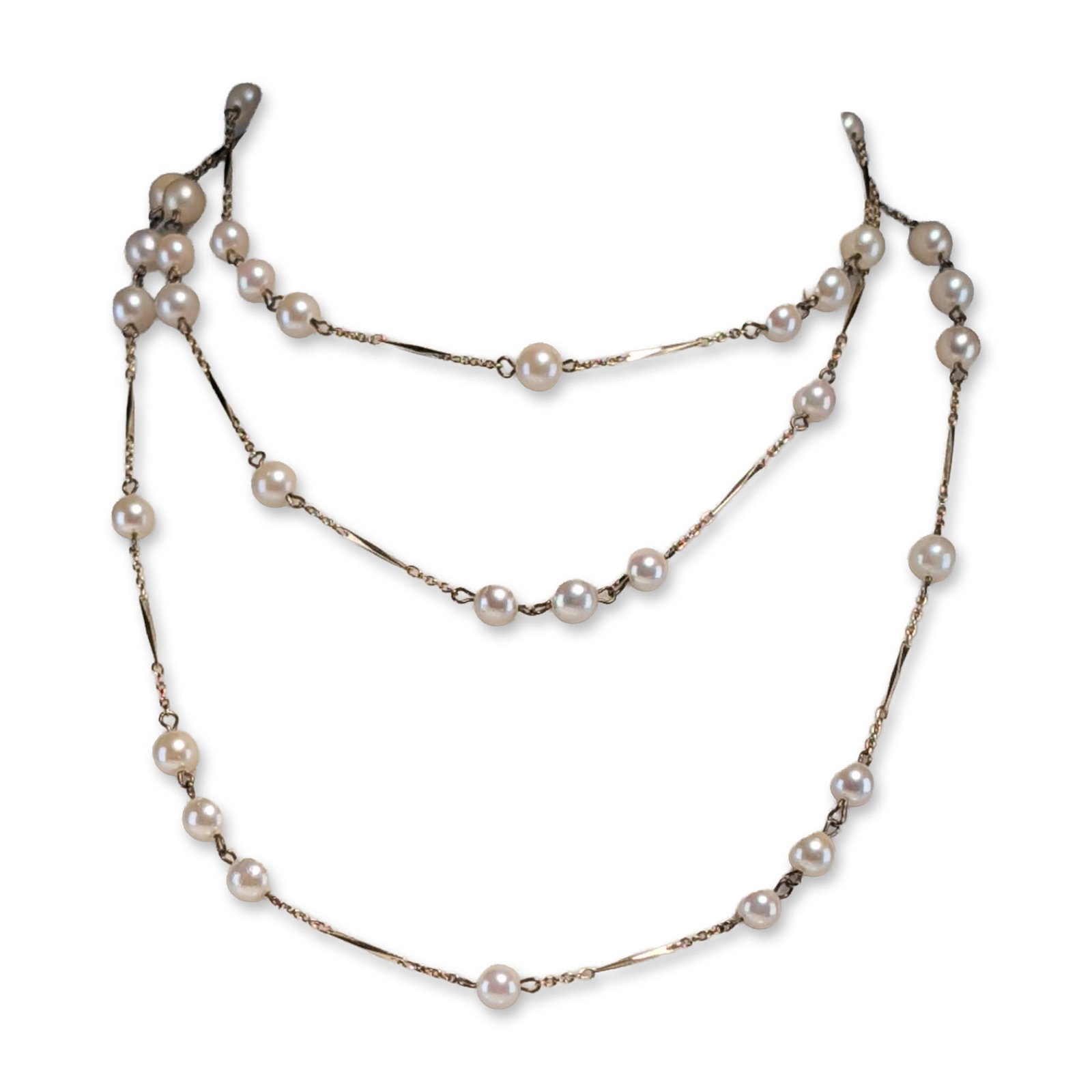 Nakagawa Sterling Silver Cultured Pearl Station Necklace: Nakagawa long station-style necklace in gold-plated sterling silver, featuring cultured pearls arranged in individual and three-pearl groupings. The pearls display white to cream body color with high 