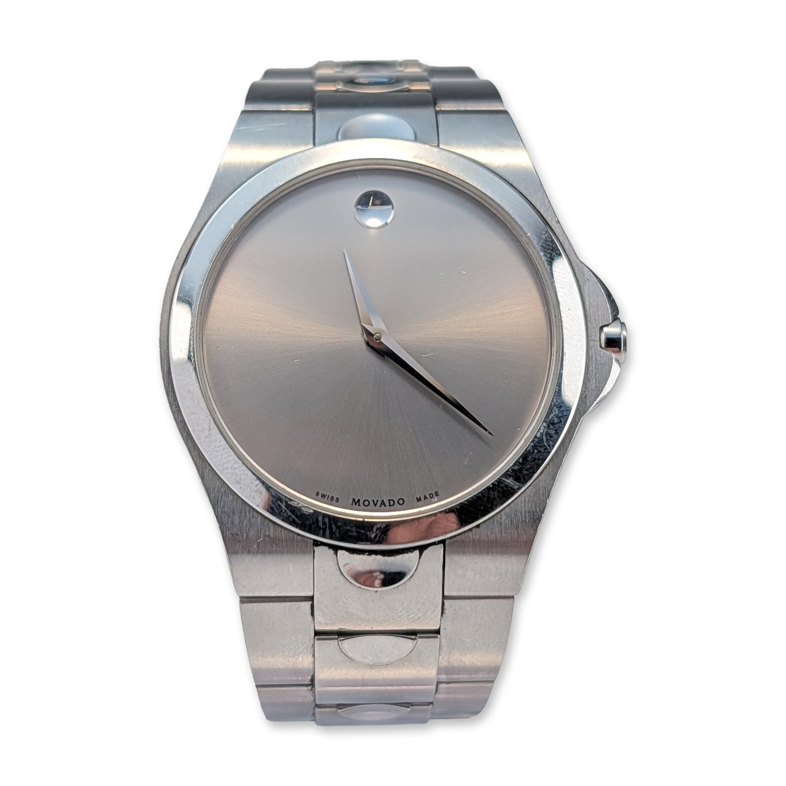 Movado Luno Sport Stainless Steel Men Watch: Movado Luno Sport men's wristwatch in stainless steel, featuring a silver sunray Museum dial with a signature concave dot at the 12 o'clock position and silver-tone hands. The timepiece includes a scr