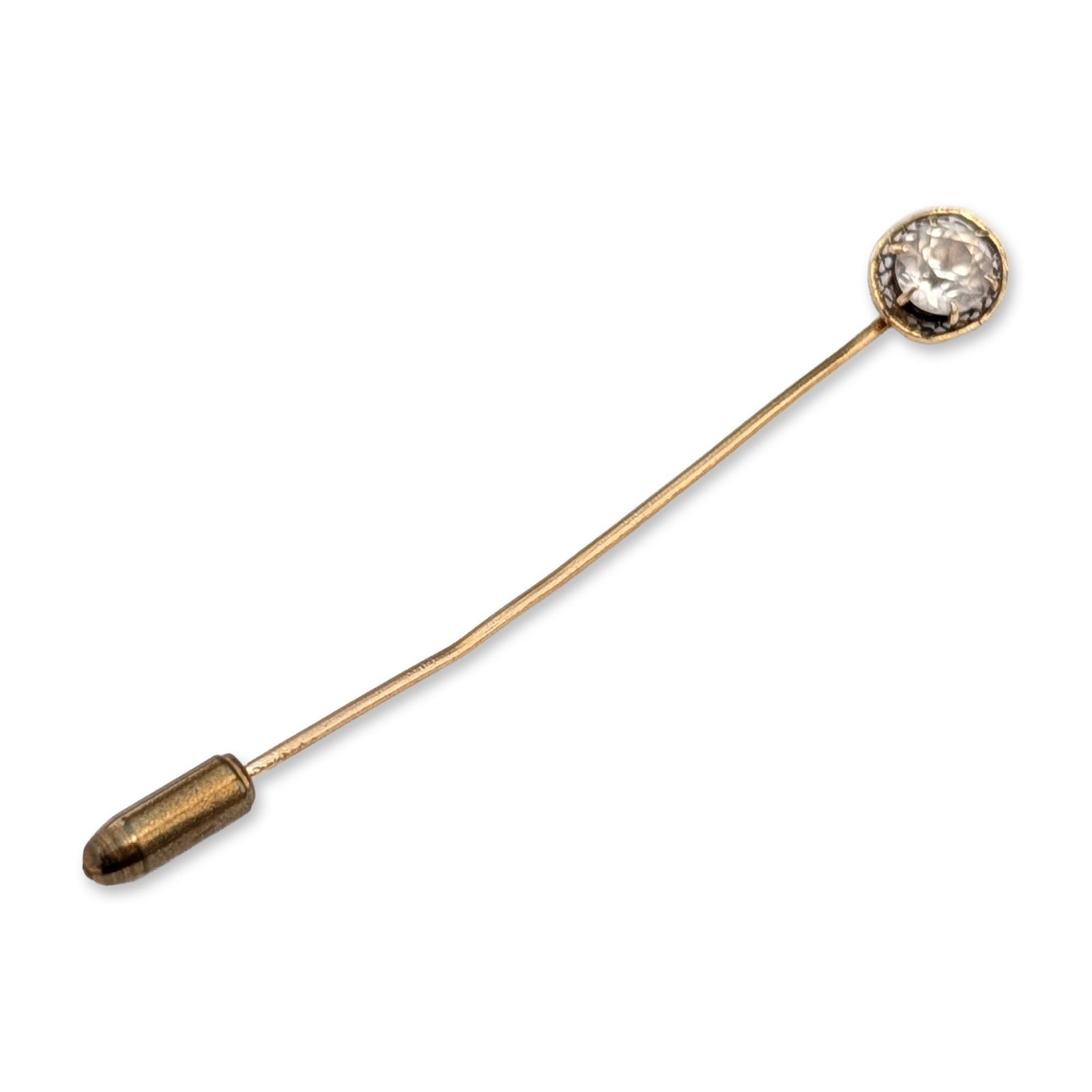 14K Yellow Gold White Sapphire Stick Pin: Stick pin in 14 karat yellow gold. The circular head features a single round-cut clear gemstone secured in a six-prong setting and surrounded by an openwork scroll filigree gallery. The gemstone displ