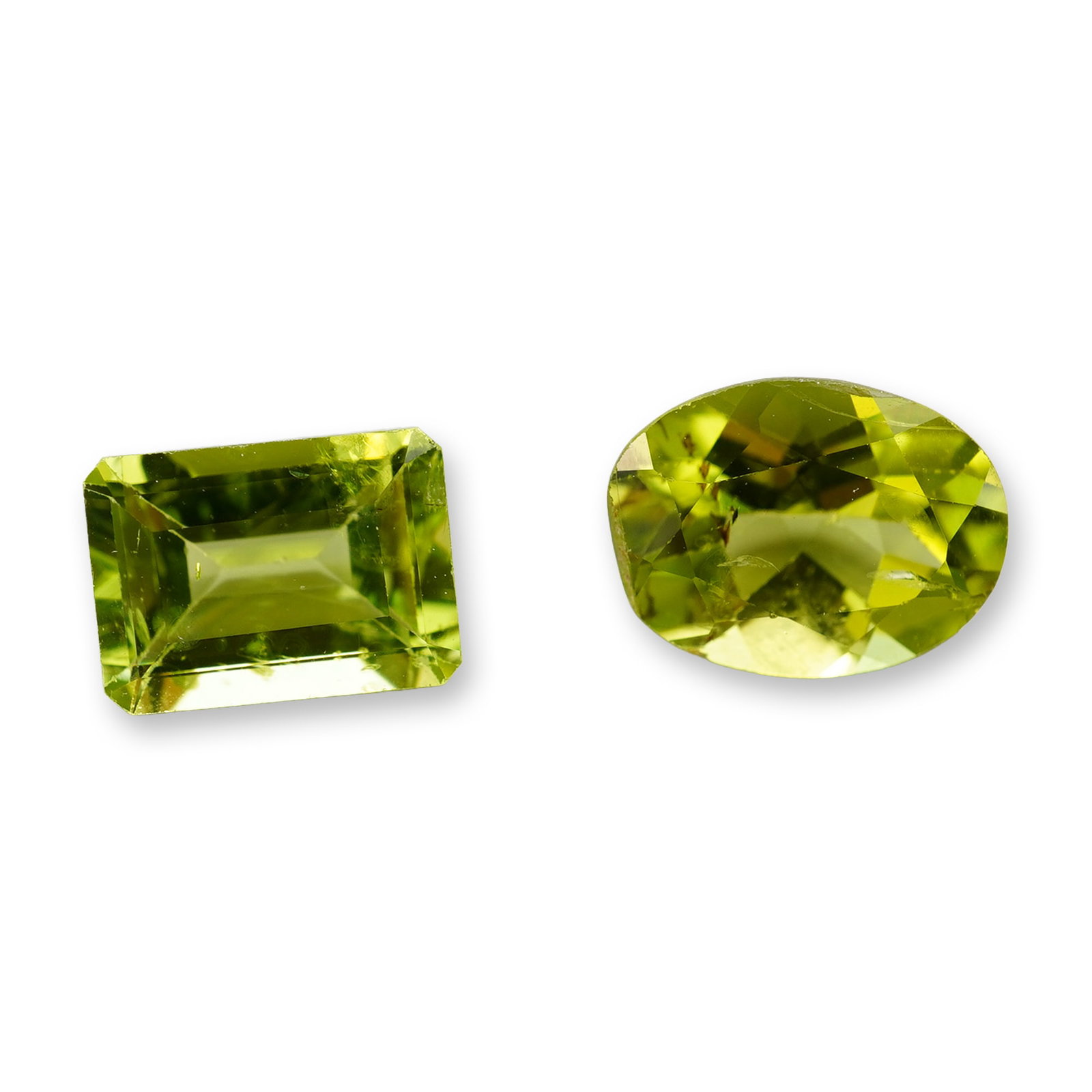 2pc Peridot Gemstones: Collection of nine loose gemstones appearing to be rubellite tourmaline in a rich spectrum of pinkish-red hues. The assortment features a variety of classic shapes including three emerald step cuts, t