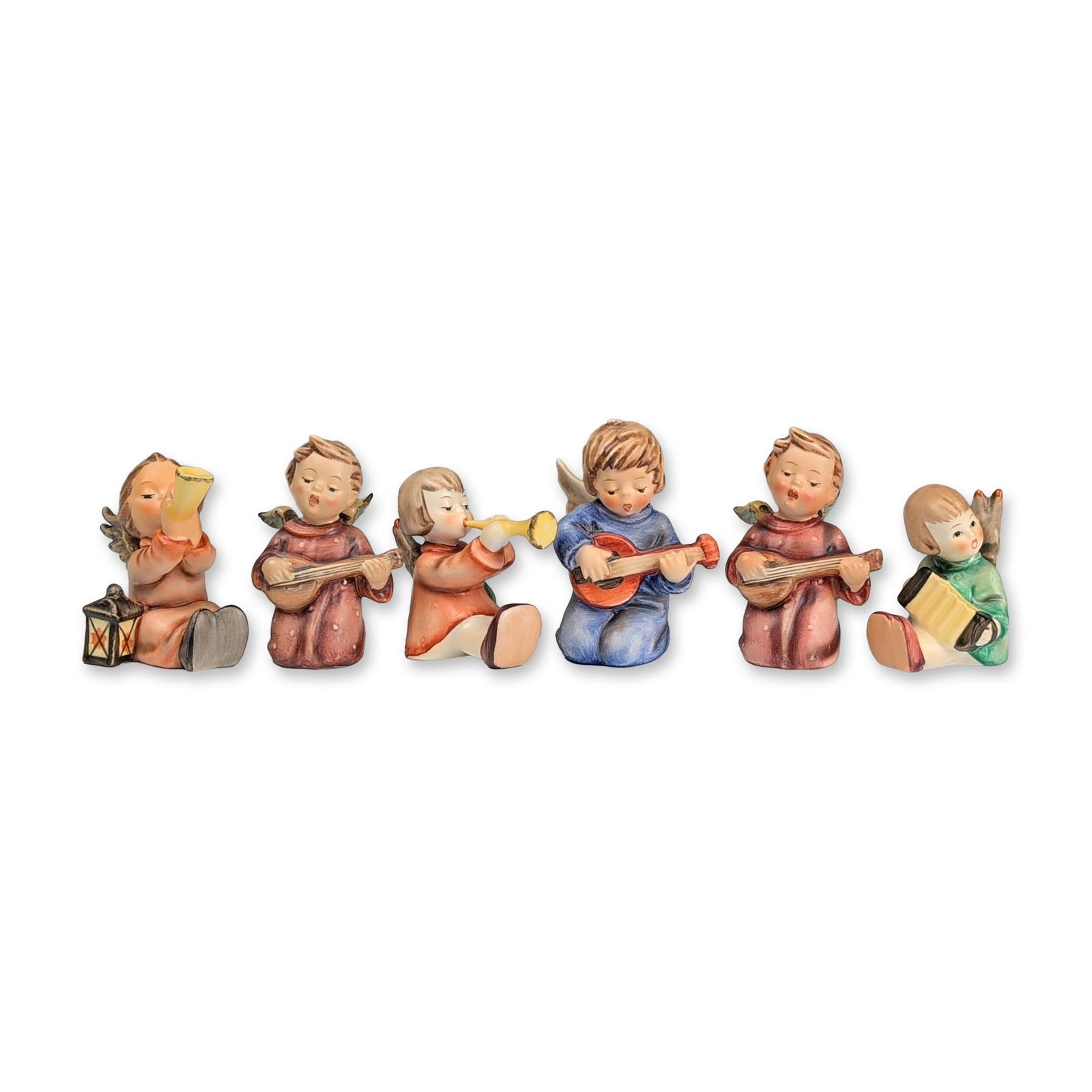 Collection of Six Goebel Hummel Musical Angels Figurines: Goebel (West Germany). Set of six hand-painted porcelain musical angel figurines with matte finishes. The collection includes angels playing string instruments, horns and accordion. Bases are marked