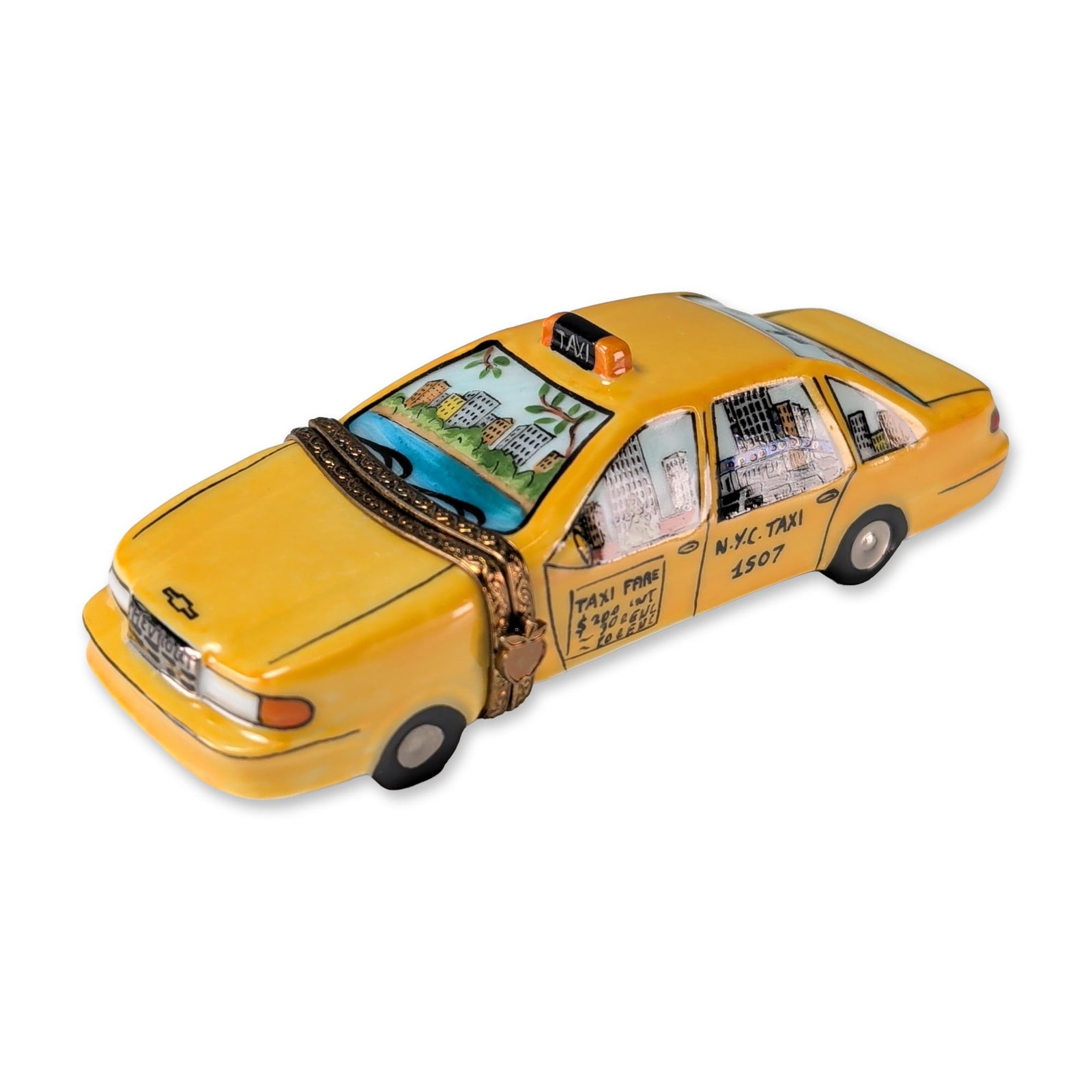 Carenton Porcelaine Limoges New York Taxi Box: Carenton Porcelaine French hand-painted Limoges porcelain trinket box modeled as a New York City yellow taxi. The piece features detailed hand-painted vignettes of city landmarks including the Statue 