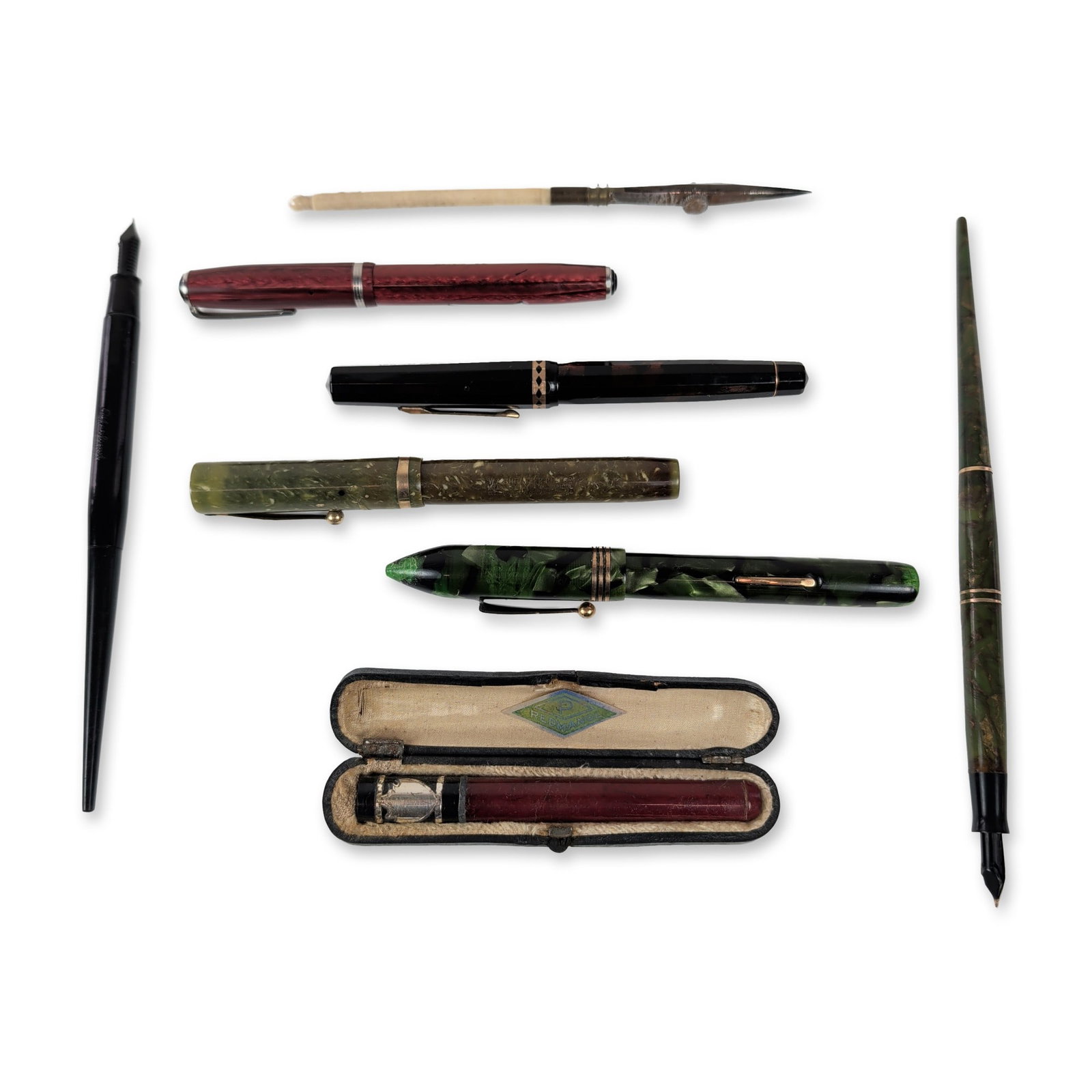 Collection of Eight Vintage Writing, Drafting, Instruments and More: Collection of vintage writing and drafting instruments crafted from celluloid, resin, and metal. The group includes assorted lever-fill fountain pens, two desk pens, a technical ruling pen, and a