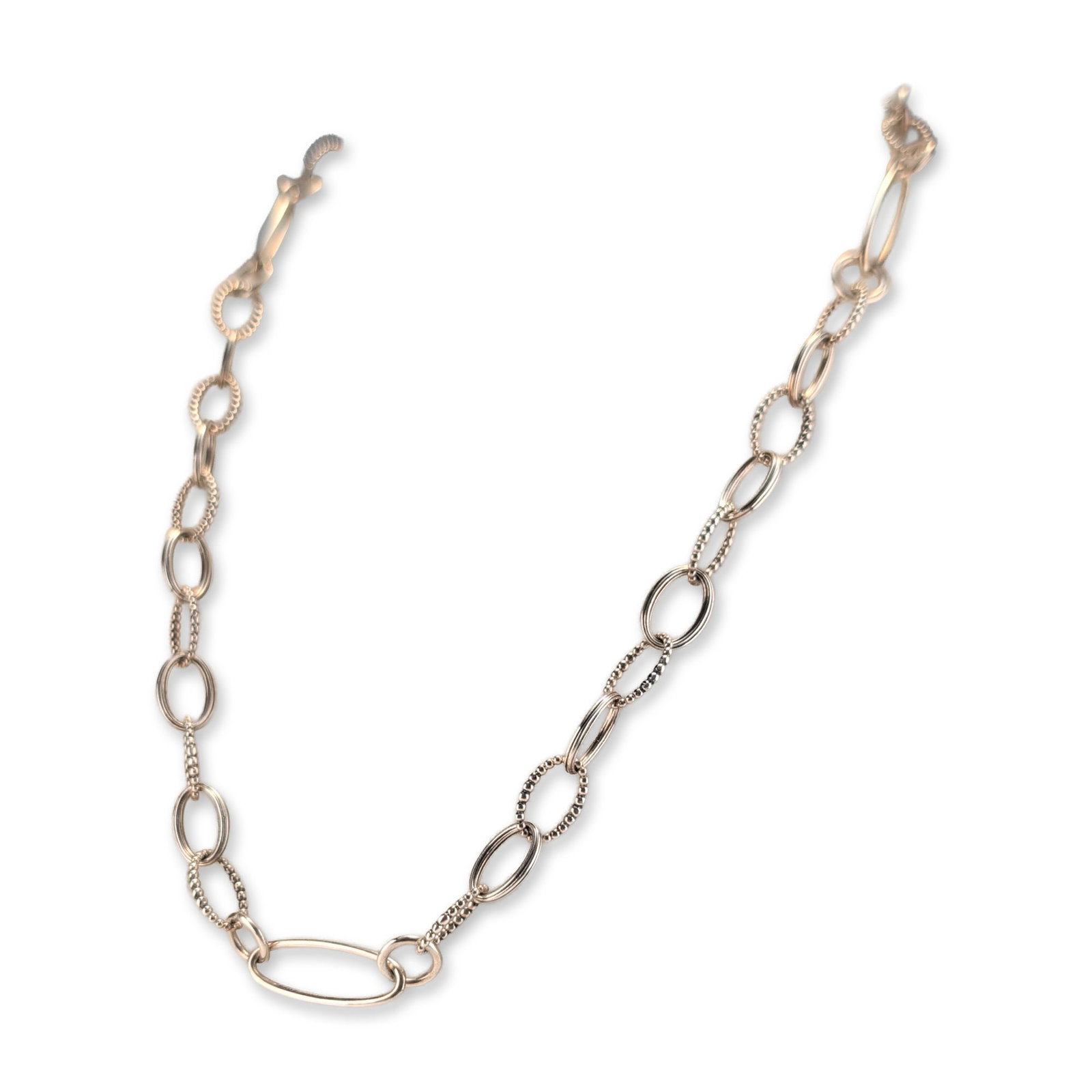 Lagos Sterling Silver Caviar Link Necklace: Ryujukai association jewelry set in gold-tone metal with red-colored centers. The group includes a thin link chain necklace and a matching octagonal lapel pin. The necklace features an oval pendant wi