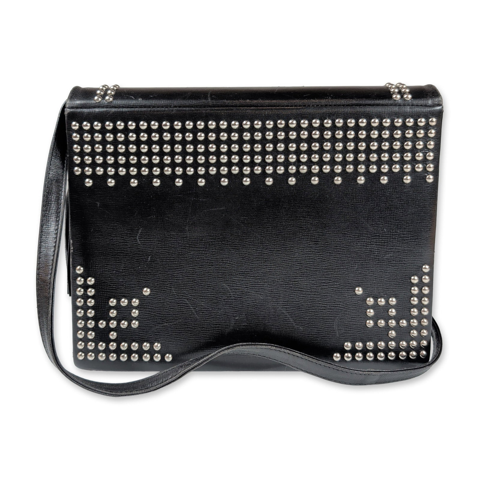 Paloma Picasso Italian Studded Leather Shoulder Bag: Paloma Picasso. Italian-made shoulder bag in black textured leather, featuring extensive silver-tone metal studding in geometric patterns on the front and sides. The bag includes a magnetic snap closu