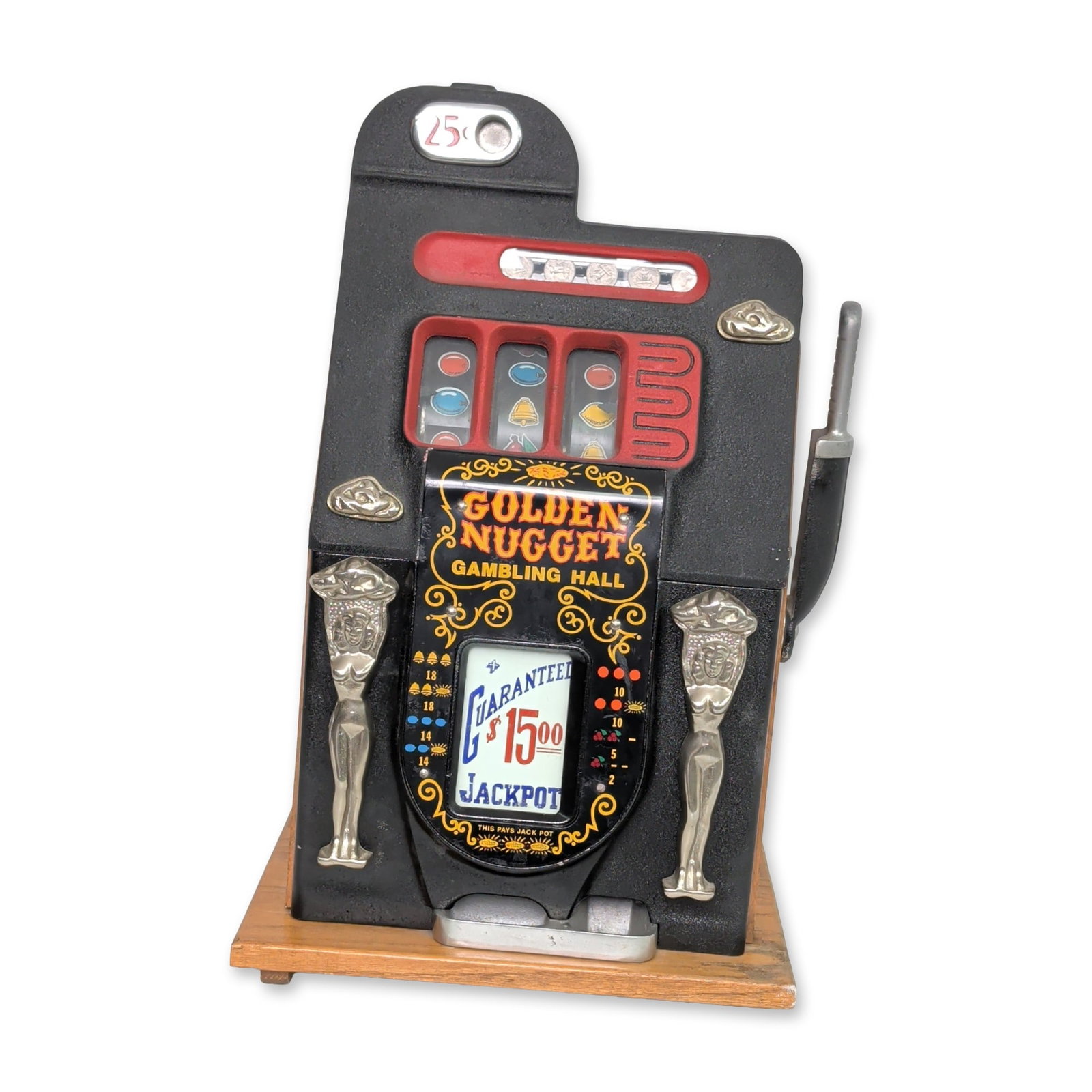 Golden Nugget Mechanical Slot Machine Bank: Golden Nugget Gambling Hall mechanical slot machine coin bank. Constructed with a cast metal front panel featuring a black crinkle-finish and yellow and orange stylized graphics. Decorative chrome-pla