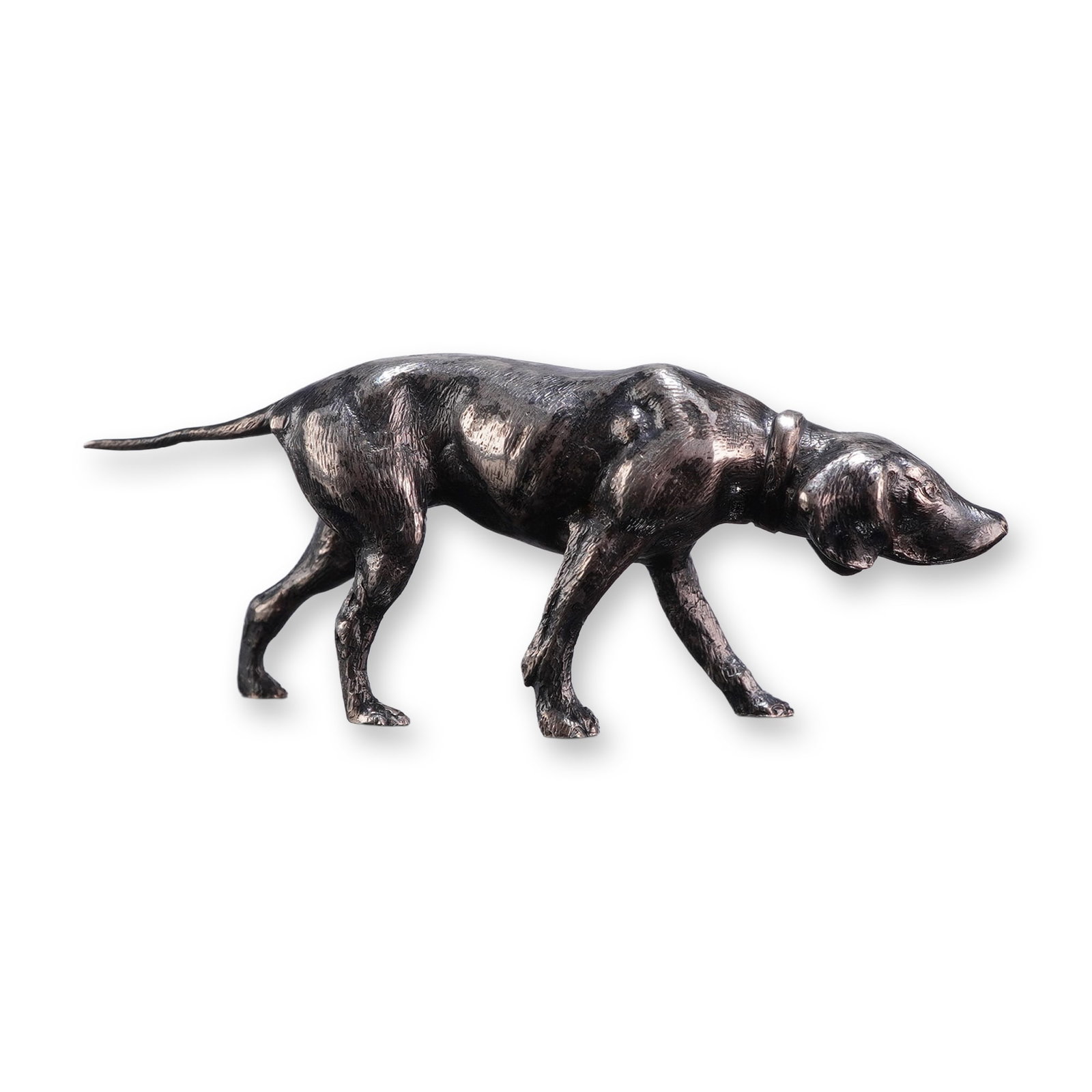 German 800 Silver Hunting Dog Figurine: German post-1888 hunting dog figurine in 800 fine silver, realistically cast in a tracking stance with its head lowered, tail extended, and front left paw slightly forward. The dog is detailed with a 