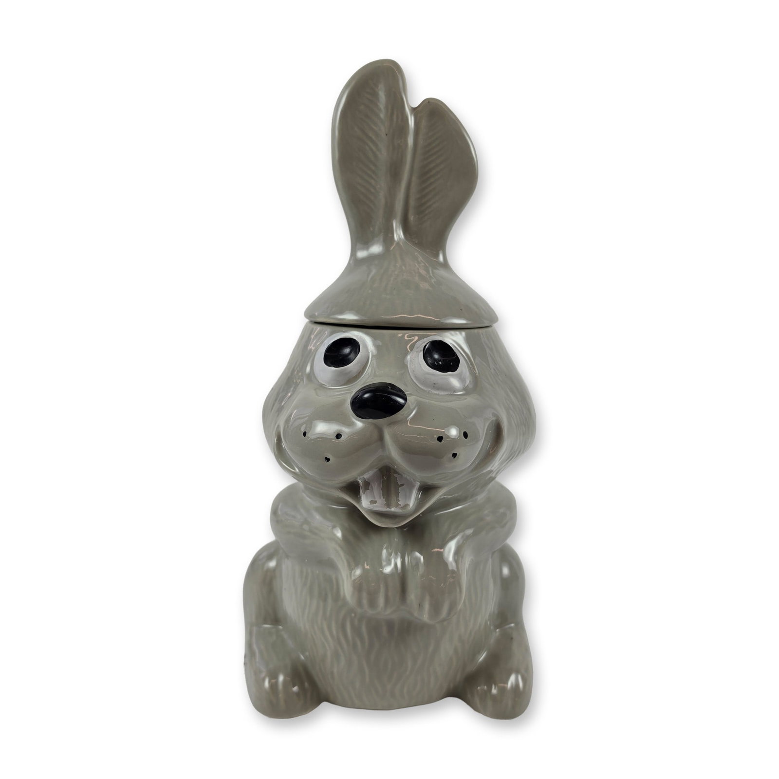 McCoy Pottery Gray Ceramic Rabbit Cookie Jar: McCoy Pottery. Cookie jar in the form of a seated rabbit, executed in gray glazed ceramic. The figure features stylized facial features including oversized eyes, a black nose, and prominent white buck