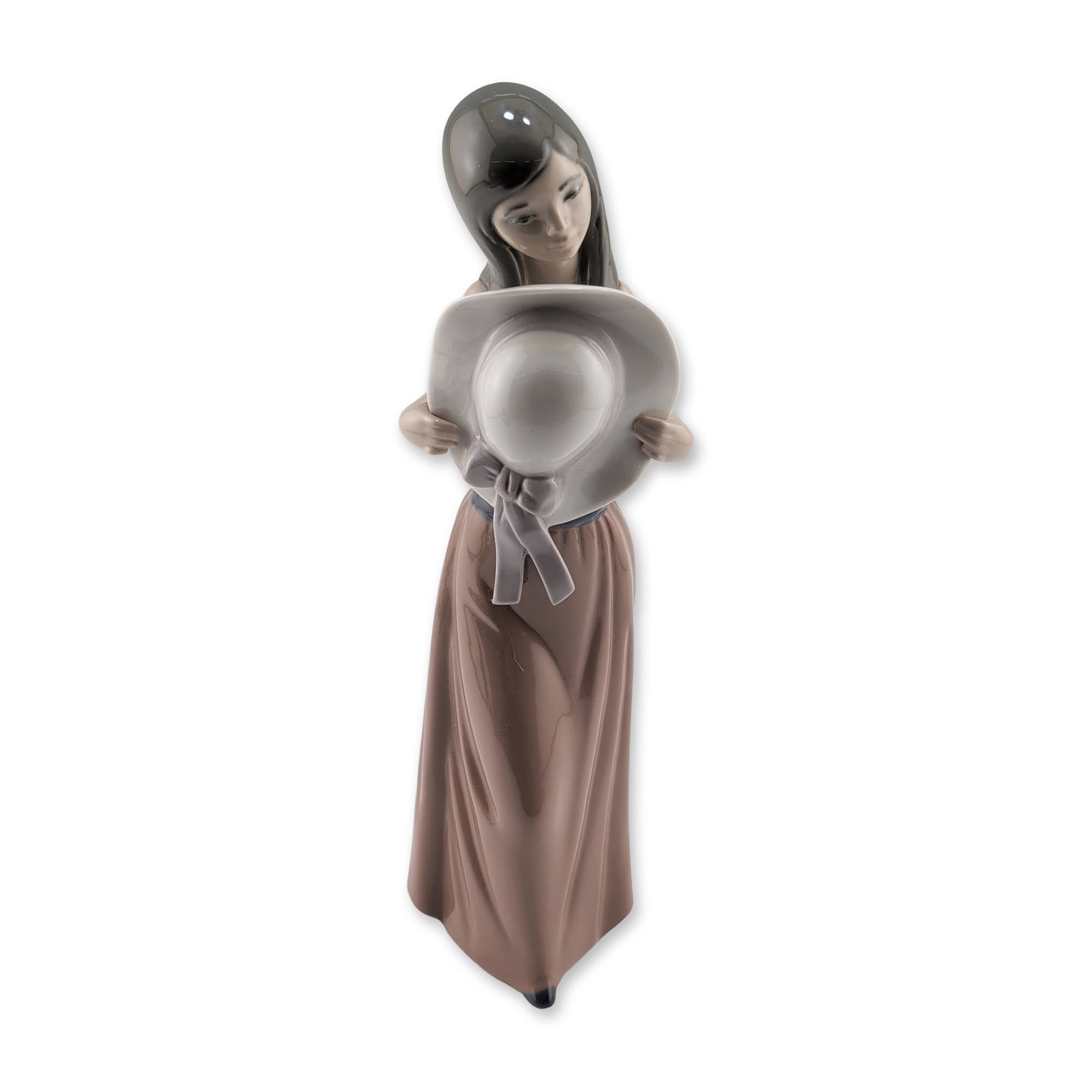 Lladro A Sunny Day Porcelain Figurine: Lladro glazed porcelain figurine titled A Sunny Day, model number 5007, designed by Jose Puche. The piece depicts a slender young woman with long dark hair wearing a floor-length mauve dress accented 