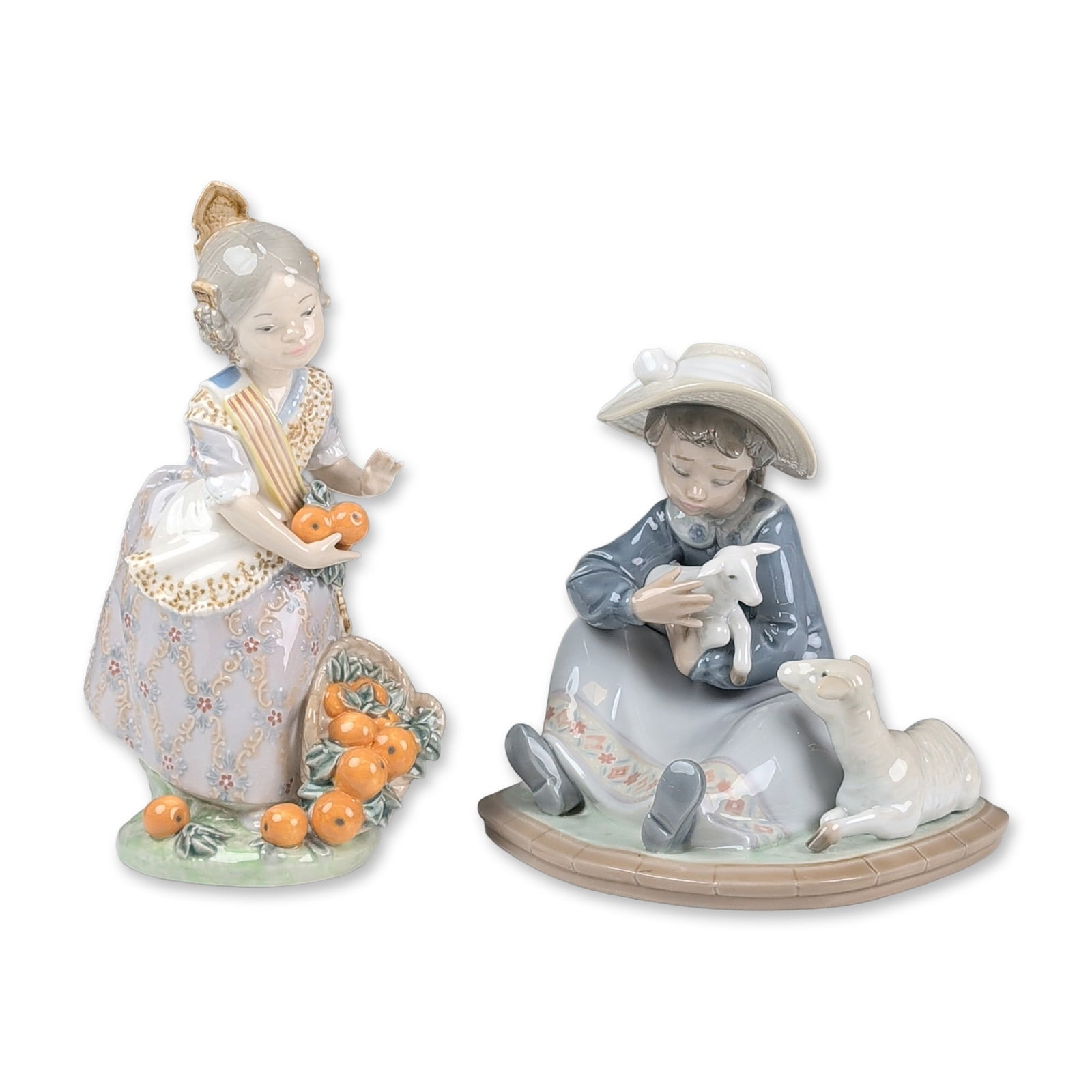2pc Lladro Porcelain Figurines, Miss Valencia 01001422 & Lambkins 01005469: Two glazed porcelain figurines including Lambkins (model 5469) and Miss Valencia (model 1422). Lambkins depicts a seated girl in a straw hat and blue blouse cradling a white lamb with a mother lamb lo