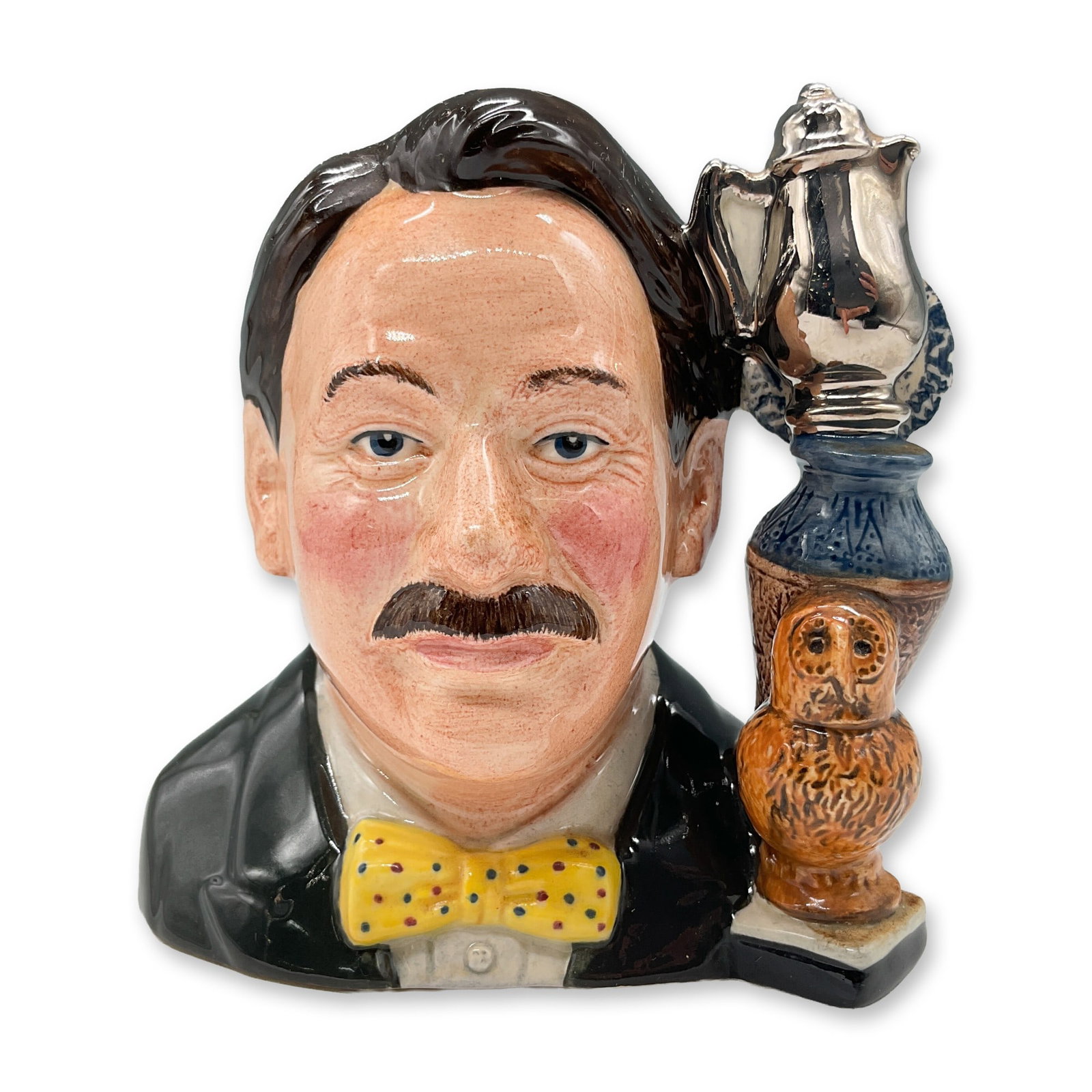Royal Doulton Character Jug, Eric Knowles Design: This Royal Doulton character jug, designed by Eric Knowles, features a delightful depiction of a gentleman holding a teapot, highlighted with vibrant colors and fine detailing. The piece is part of a 