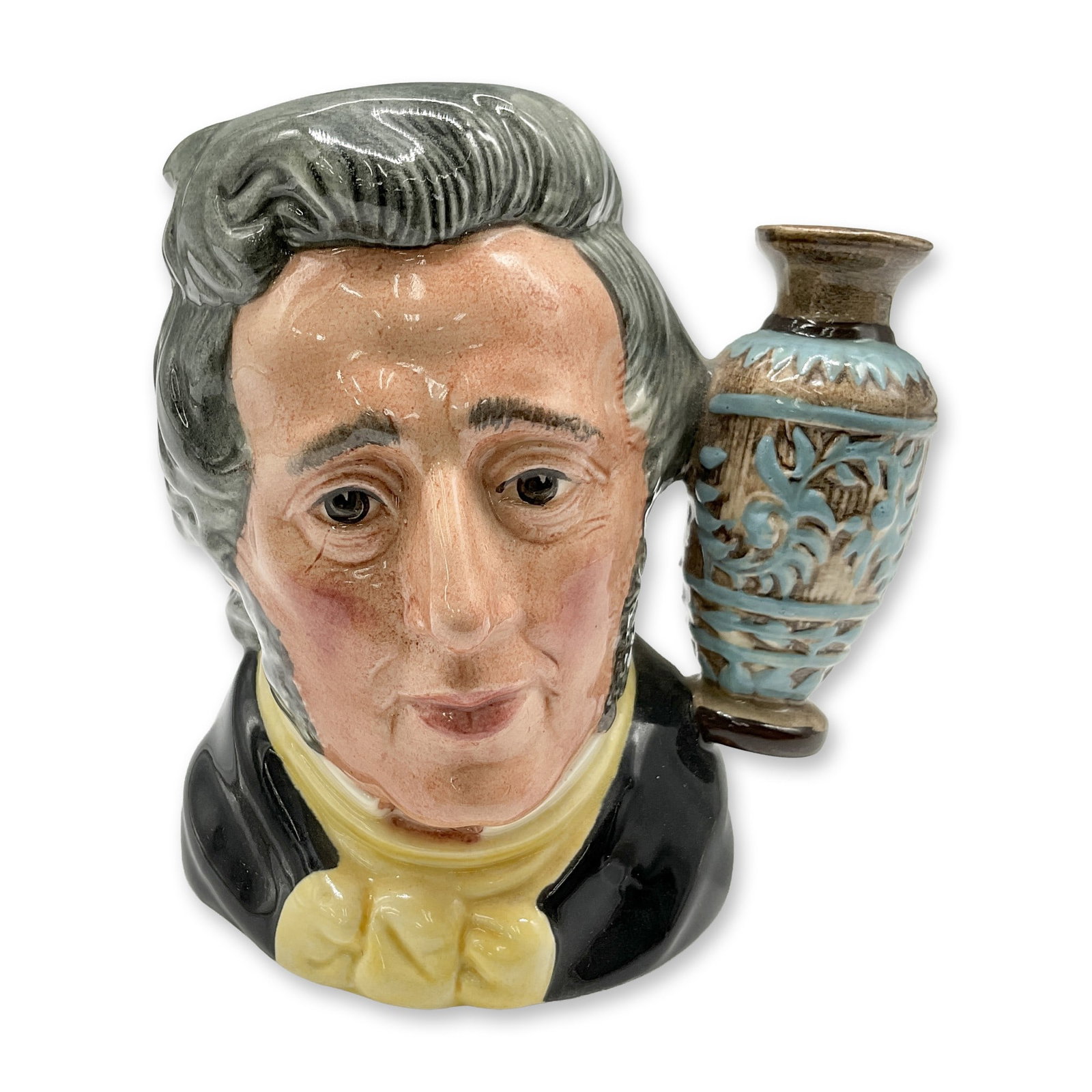 Royal Doulton Small Character Jug, Sir Henry Doulton D6703: Character Jug, featuring Sir Henry Doulton with his distinguished black coat, vibrant yellow cravat, and elegant grey hair, beautifully accented by a brown and blue vase. Royal Doulton backstamp. Arti