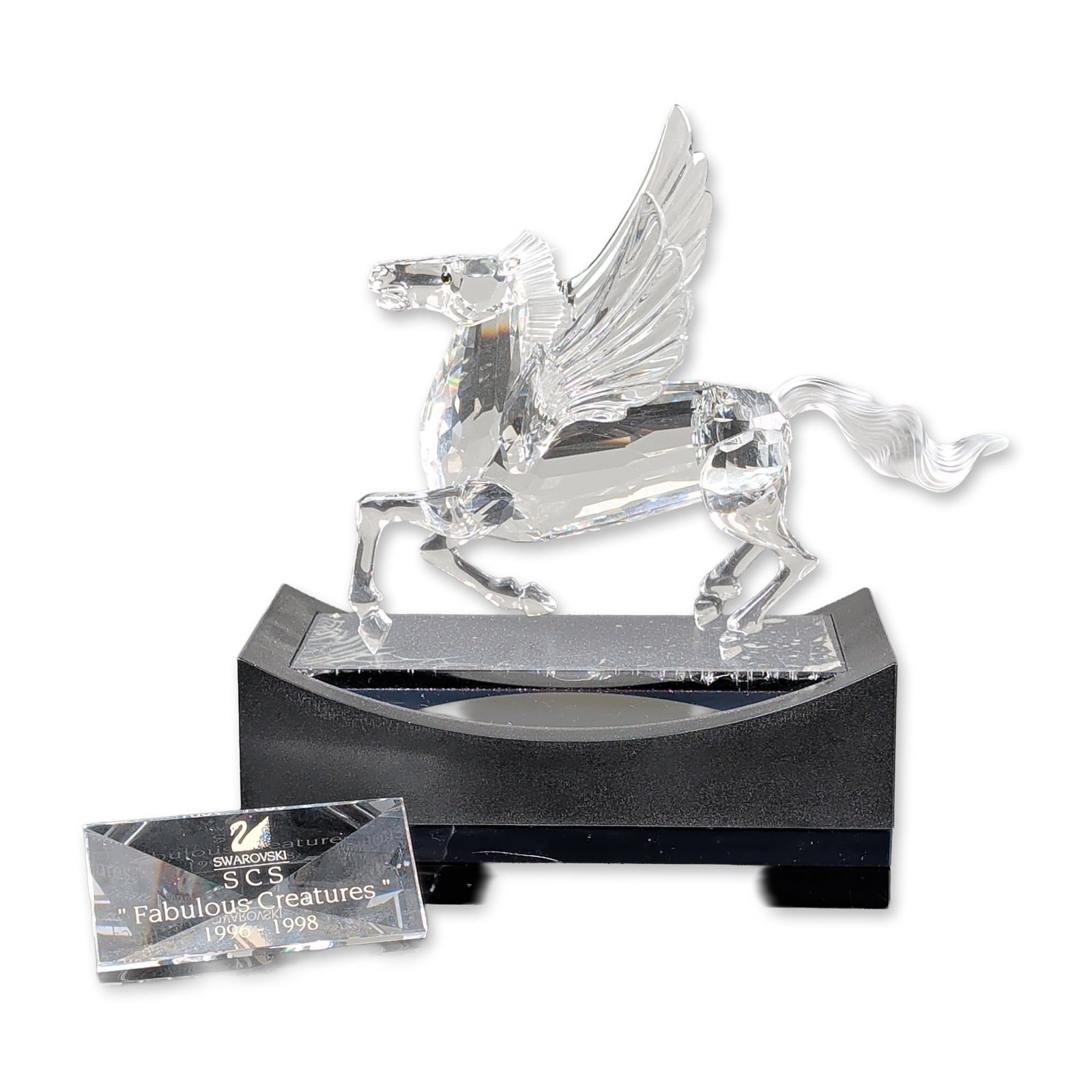 3pc Swarovski Crystal SCS 1998 Annual Edition Figurine, Pegasus with Title Plaque & Base: Swarovski SCS 1998 Annual Edition Pegasus crystal figurine, designed by Adi Stocker as the final installment of the Fabulous Creatures trilogy. The piece is constructed from faceted clear lead