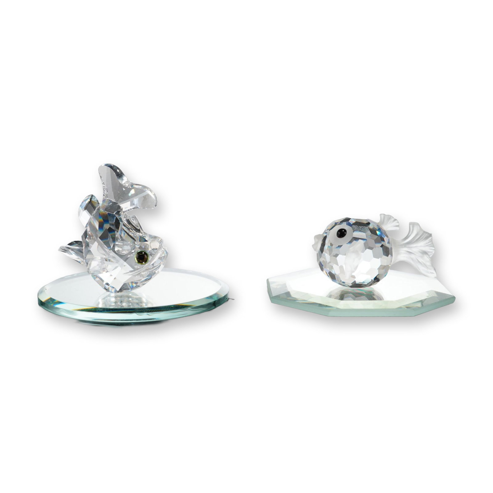 4pc Swarovski Silver Crystal Fish Figurines: Swarovski. Two faceted lead crystal fish figurines from the Silver Crystal collection, featuring a puffer fish and an upright tropical fish. The puffer fish is designed with a round faceted body,