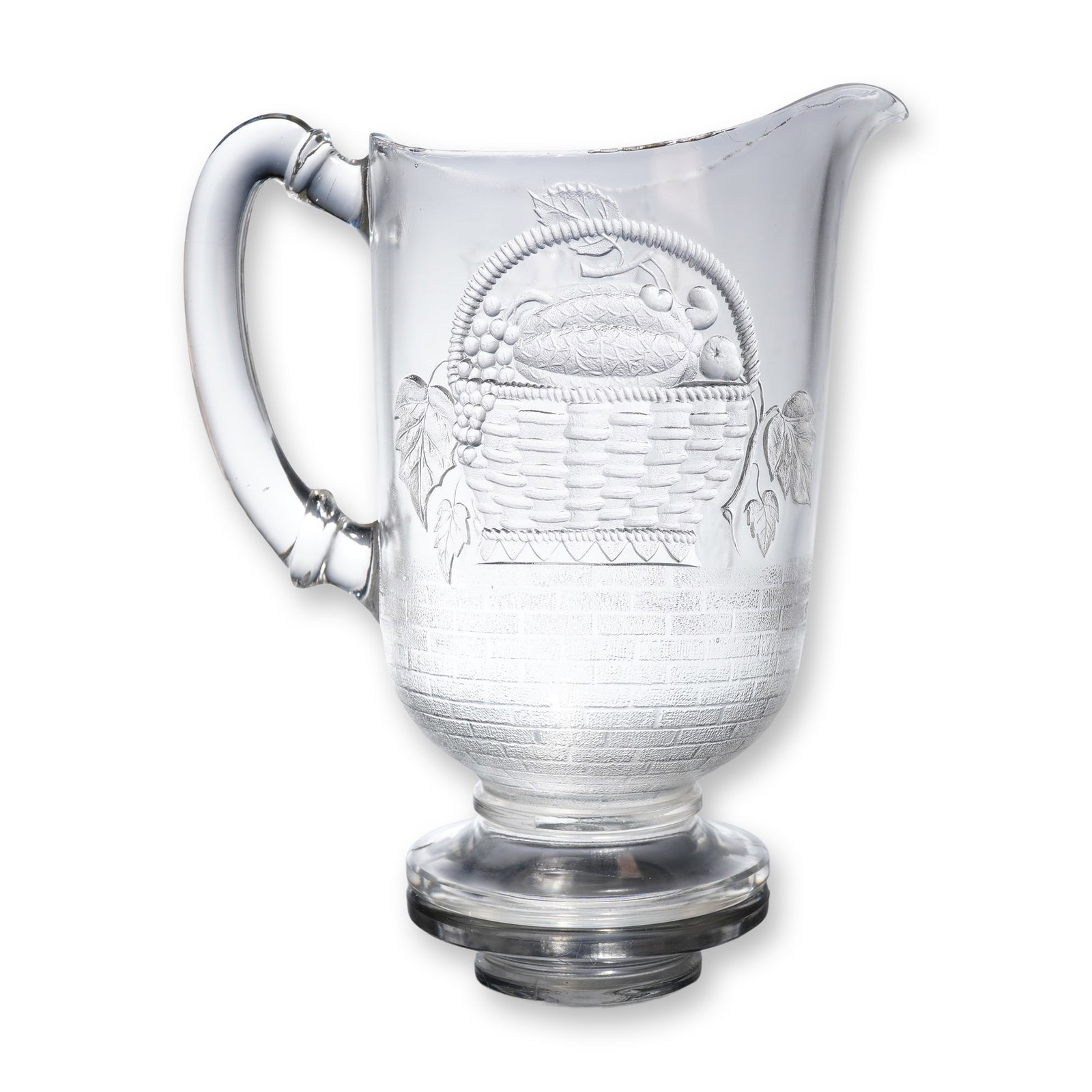 Dalzell Brothers and Gilmore Glass Pitcher, Birds and Fruit Basket: Late 19th century Dalzell Brothers and Gilmore pitcher executed in clear pressed glass and featuring a flared rim, a pouring spout, and a heavy applied c-scroll handle, resting on a substantial