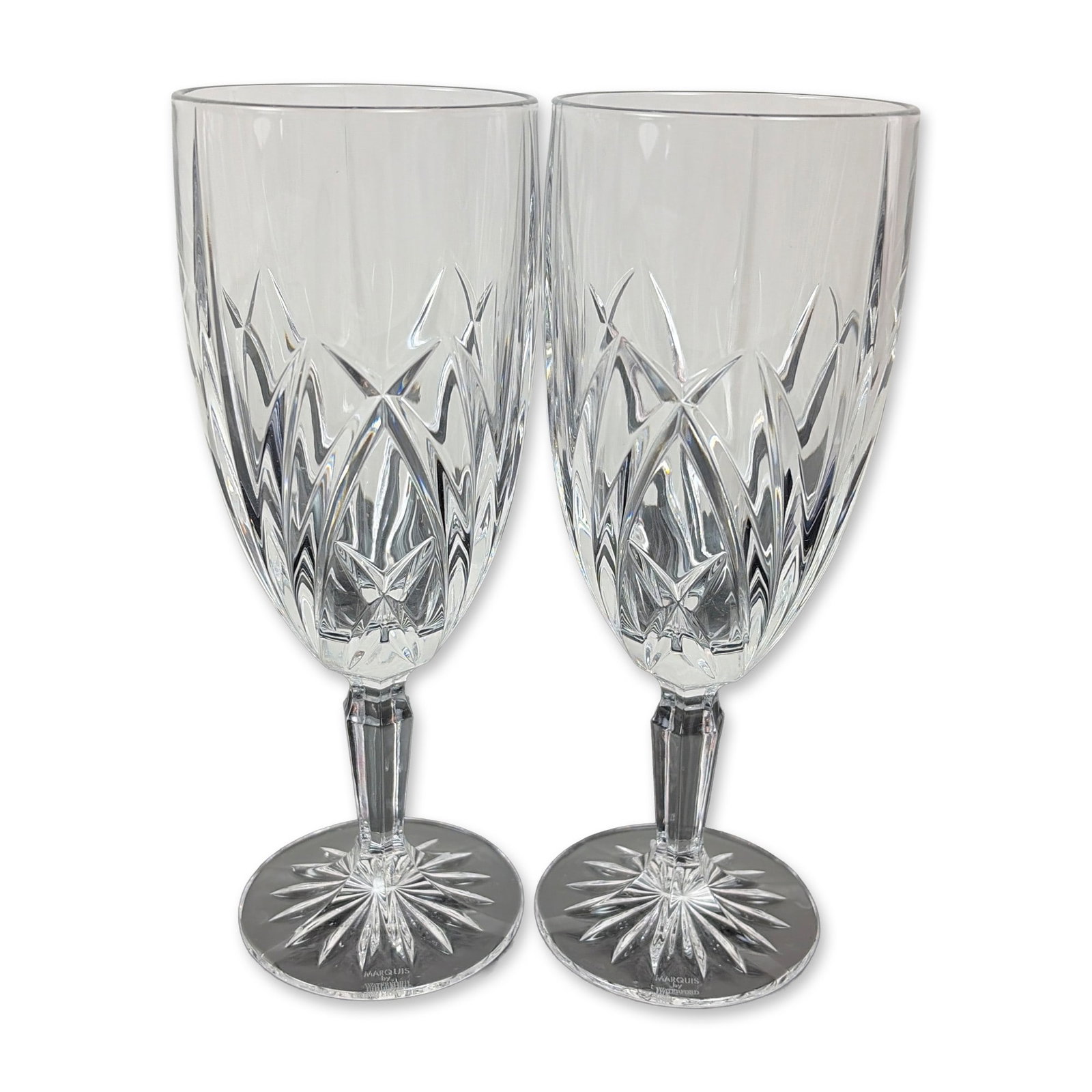 Pair of Marquis by Waterford Crystal Brookside Iced Tea Glasses: Each bowl features a lower register of deep-cut crisscross diamond motifs beneath upright wedge cuts. The design includes a multi-faceted stem and a circular foot with an underside starburst cut. Both