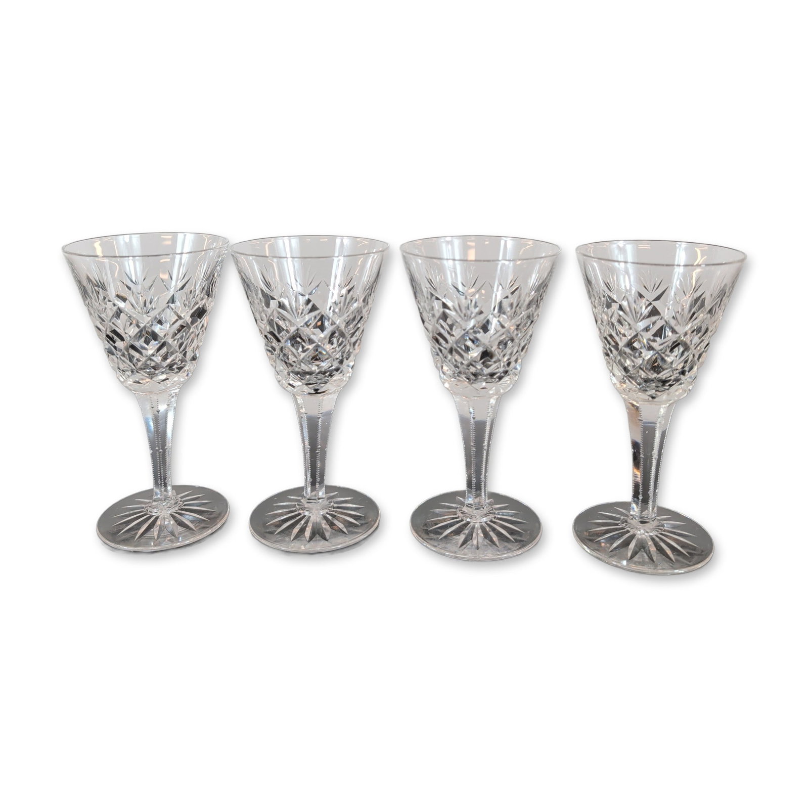 4pc Cut Crystal Stemware Glasses: Set of four cut lead crystal stemware glasses. Each glass features a flared bowl decorated with a lower register of diamond cross-hatch cuts surmounted by vertical bladed wedge cuts. The multi-faceted