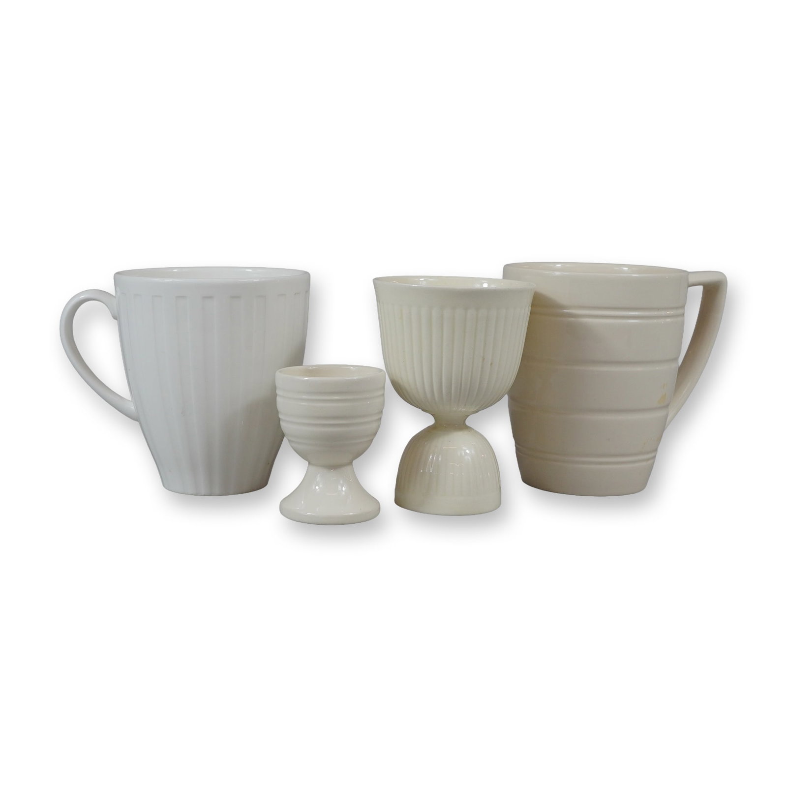 A 4 Piece Collection of Wedgwood Bone China Including Night and Day, Edme, and Conran Patterns: This assortment of four ceramic items is crafted from bone china by the manufacturer Wedgwood, England. The collection includes pieces from three distinct design lines. One white mug from the Night an