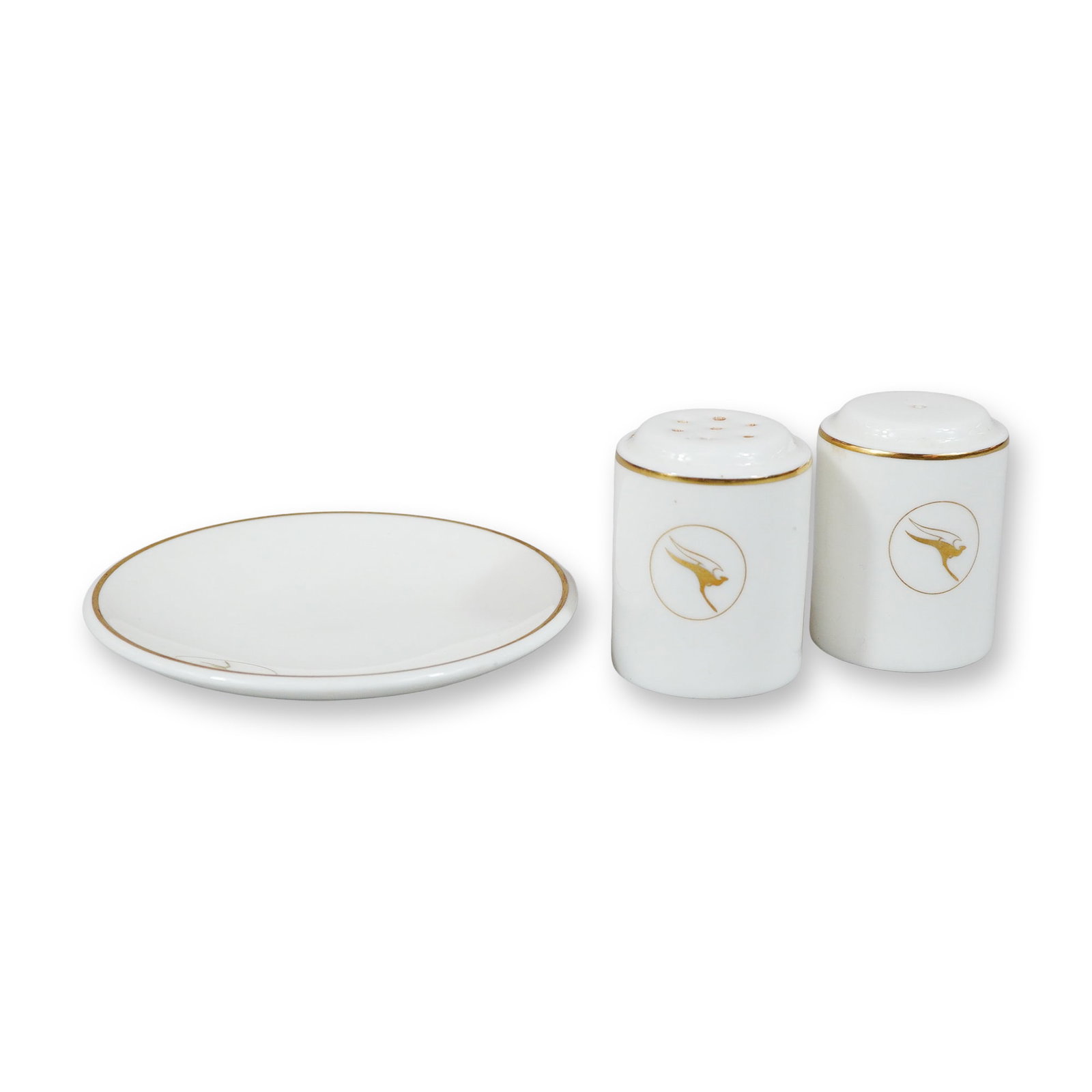 A Trio of Wedgwood Qantas Airways Bone China Airline Service Tableware: This is a trio of vintage airline service tableware manufactured by Wedgwood for Qantas Airways. The set is comprised of a circular dish and a pair of matching cylindrical salt and pepper shakers. Eac