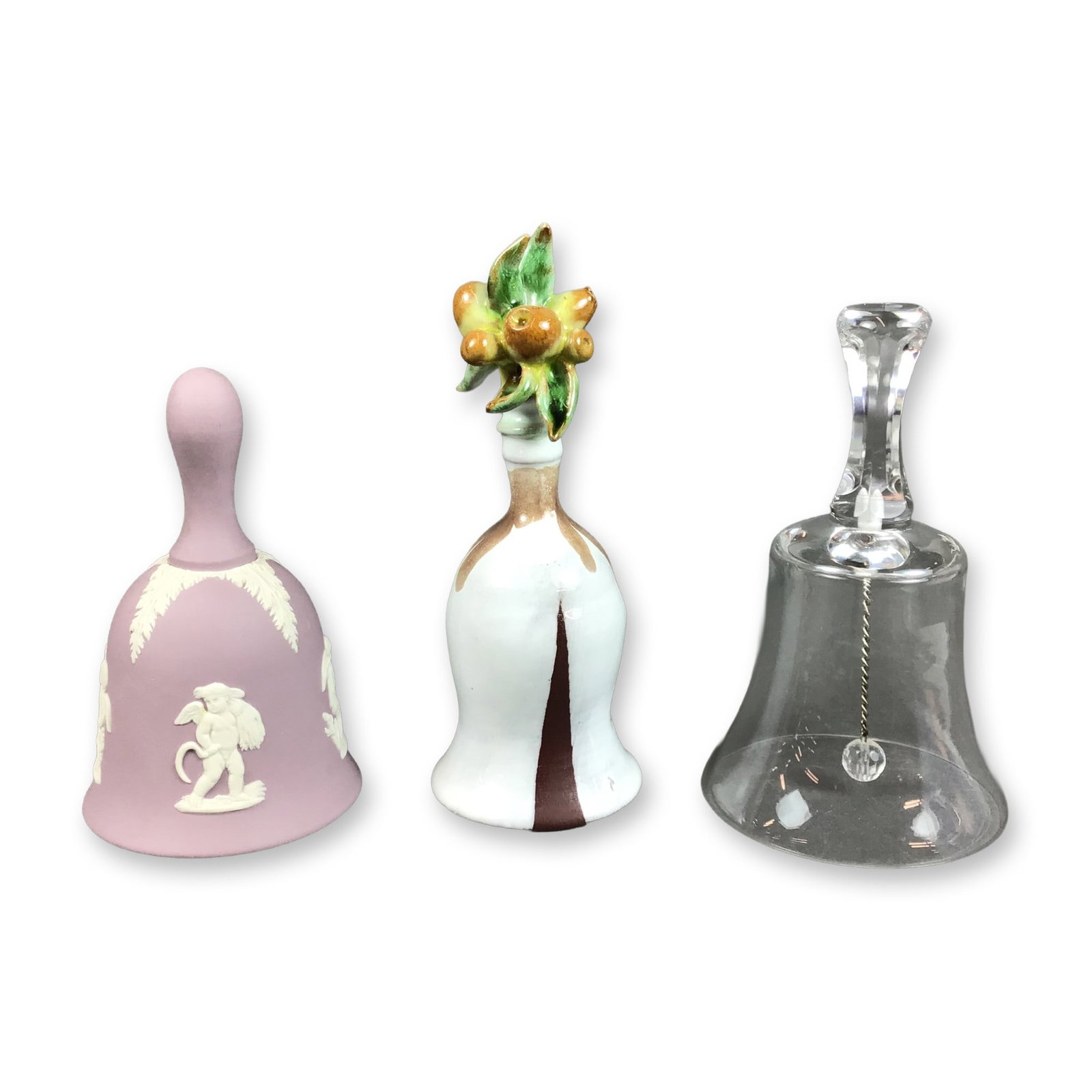 3pc Decorative Table Bells Including Wedgwood and Crystal: This collection of 3 bells features three distinct decorative styles and materials. The first is a Wedgwood lilac jasperware stoneware bell with a matte finish and white bas-relief applique. The decor