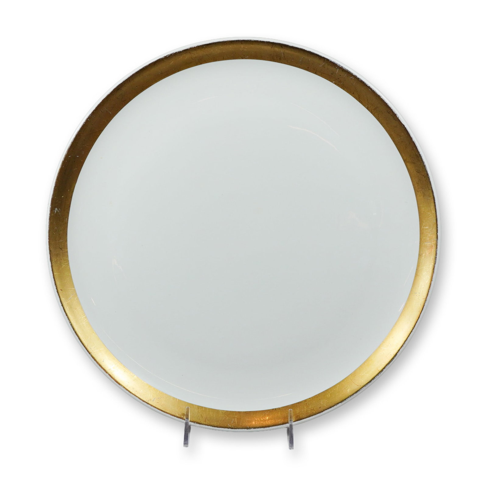 Ernest Sohn Creations Mid-Century Modern Gilt Ceramic Platter: This mid-century modern decorative platter is manufactured by Ernest Sohn Creations. The piece is constructed from white glazed ceramic and features a wide, textured gold-toned border. The platter has