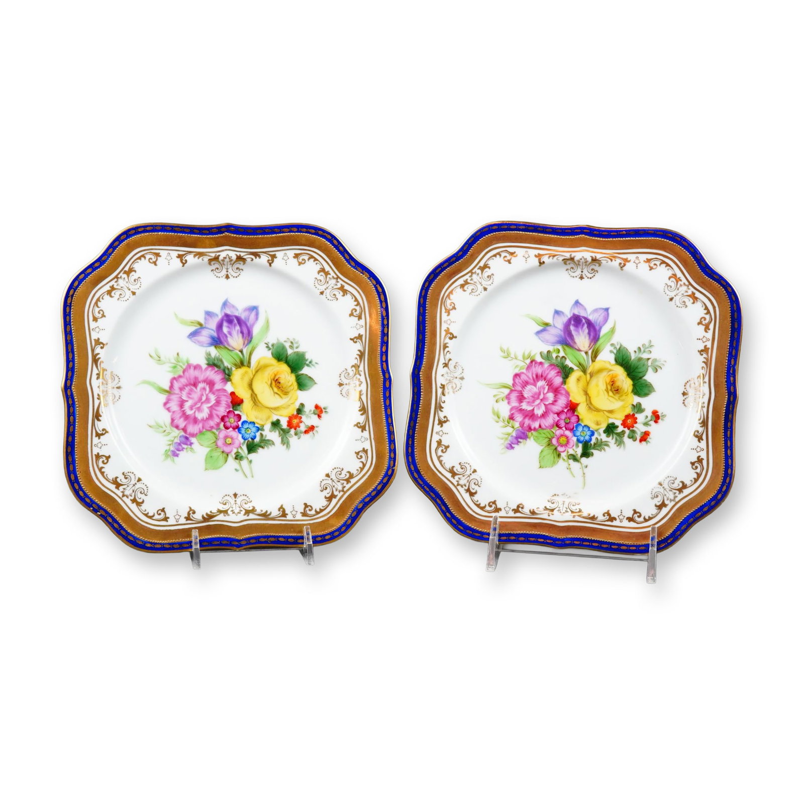 Noritake Hand-Painted Floral Porcelain Cabinet Plates: A pair of Noritake Japan handpainted floral plates crafted from fine porcelain. Each plate features a square form with elegantly scalloped, lobed corners and a slightly raised rim. The center of each 