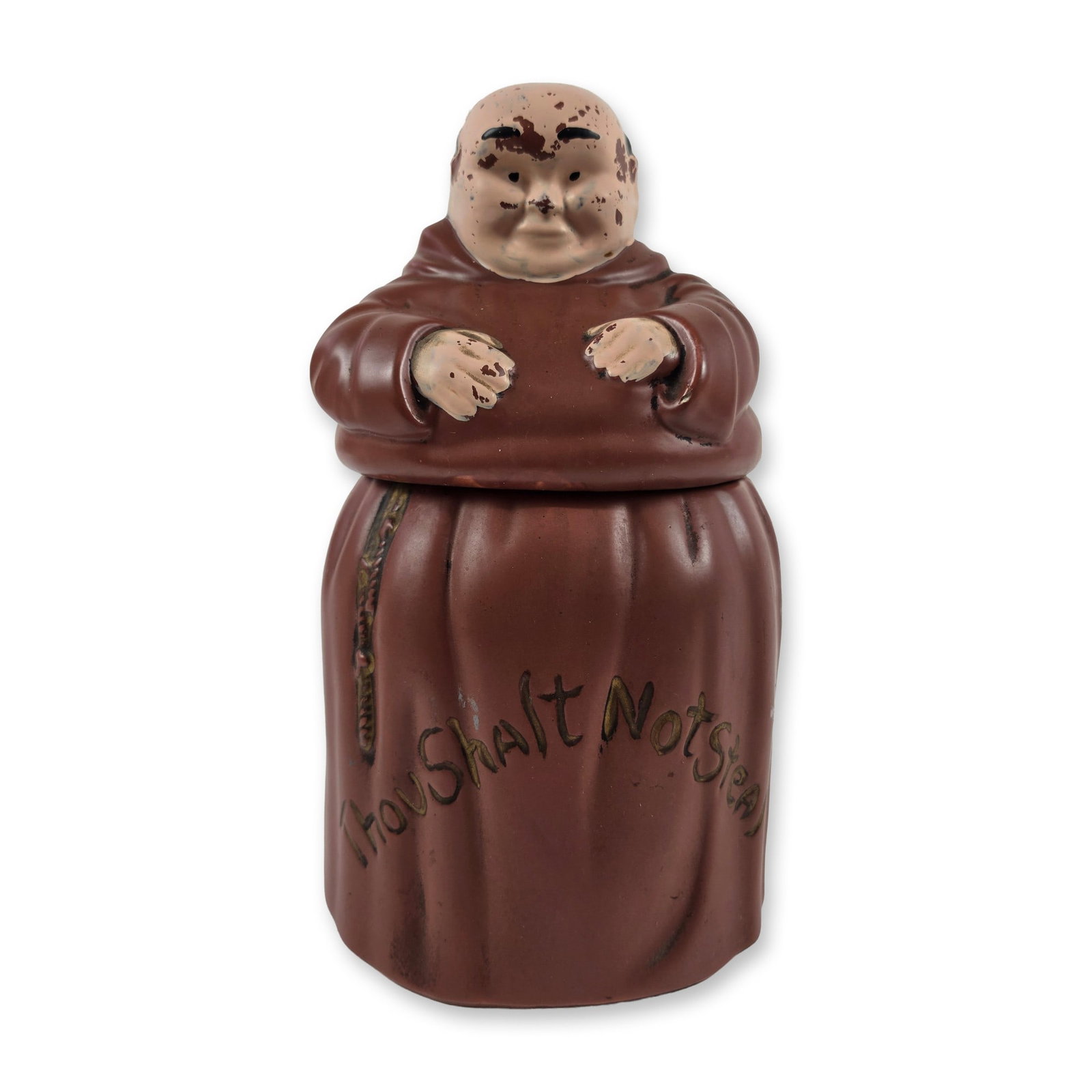 Vintage Ceramic Monk Thou Shalt Not Steal Cookie Jar: The earthenware vessel is modeled as a seated friar or monk finished in a matte brown glaze. The front of the robe features the incised commandment Thou Shalt Not Steal, which is accented with gold-to