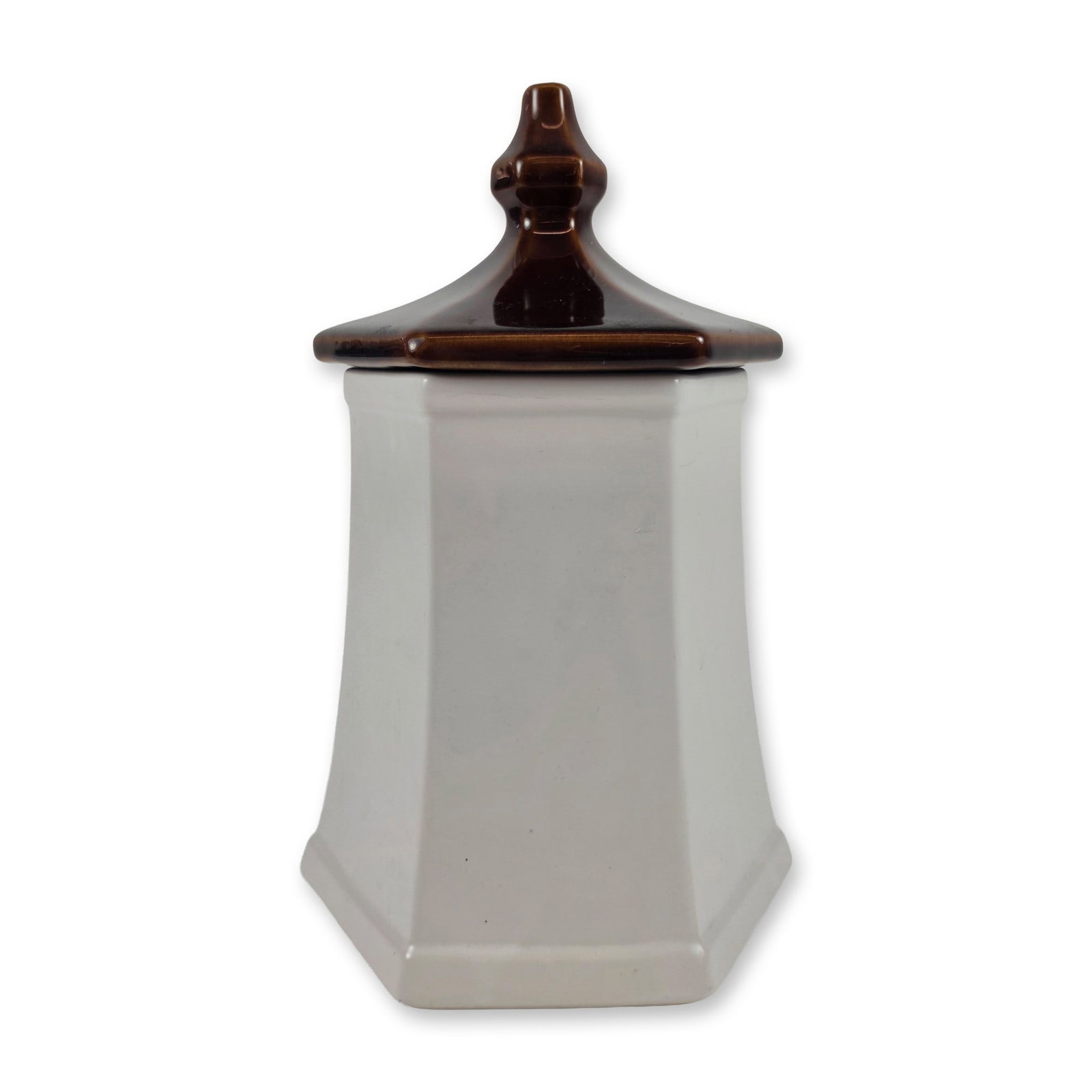McCoy Pagoda Sunflower Ceramic Canister: Hexagonal pagoda-style kitchen canister in glazed earthenware, featuring a tapered cream-colored body and a contrasting chocolate brown hexagonal lid with a molded finial. One face is decorated with