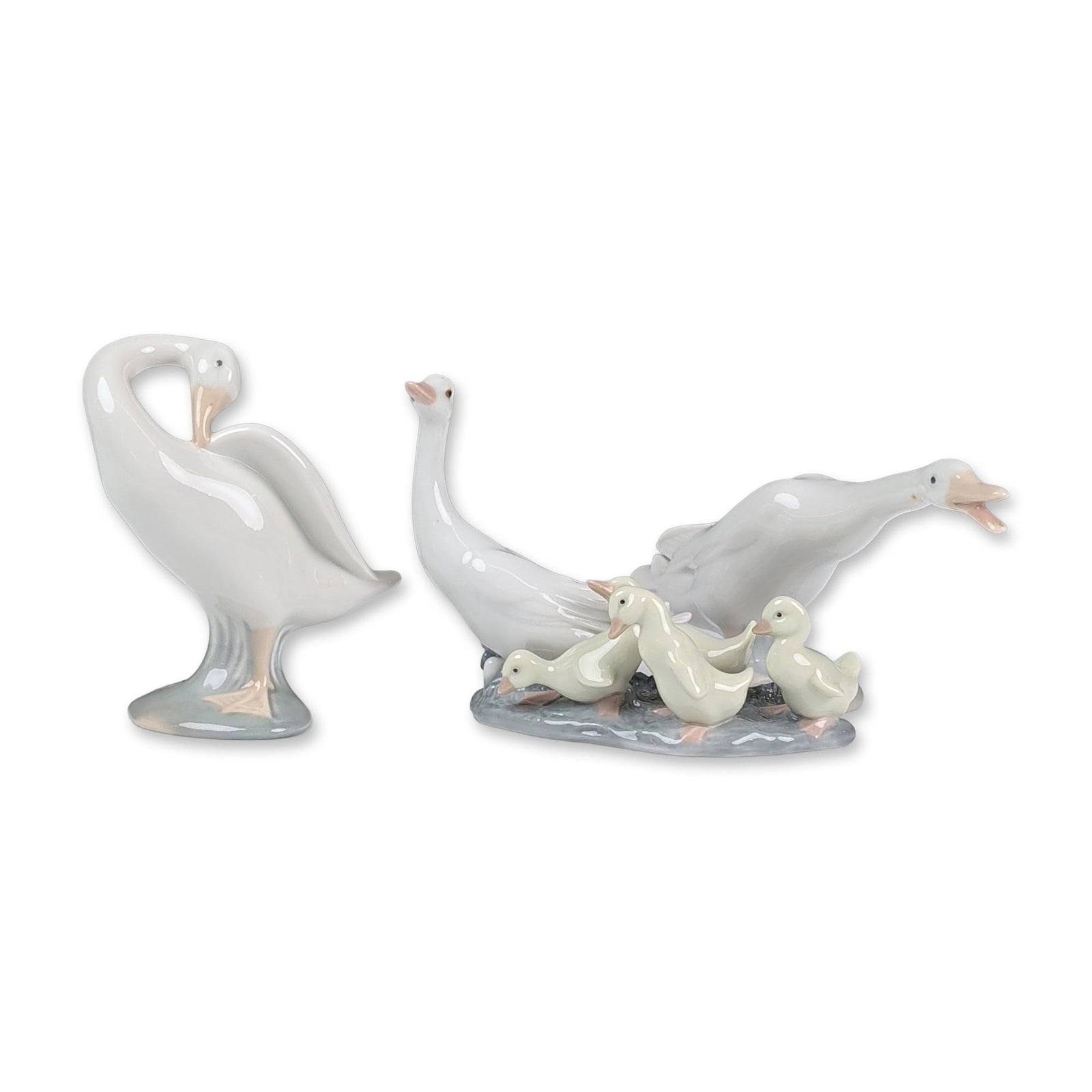 3pc Lladro Glazed Porcelain Ducks and Ducklings Figurines: Group of three glazed porcelain figurines depicting ducks and ducklings. The collection consists of Ducklings (01001307), Little Duck in a stretching pose (01004551), and Little Duck in a preening pos